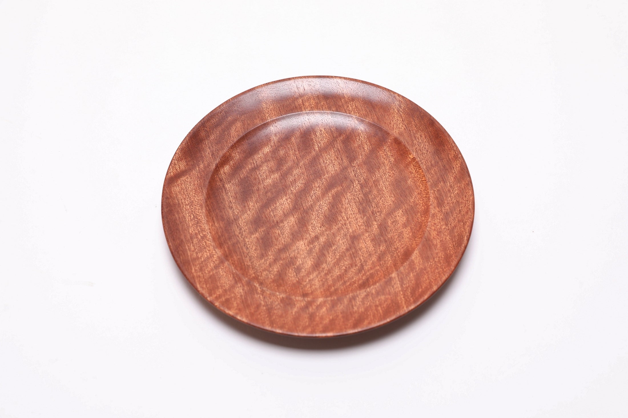 Pommele ribbon sapele wooden ring dish, top view rotated 45°, extraordinary figure radiating in natural light