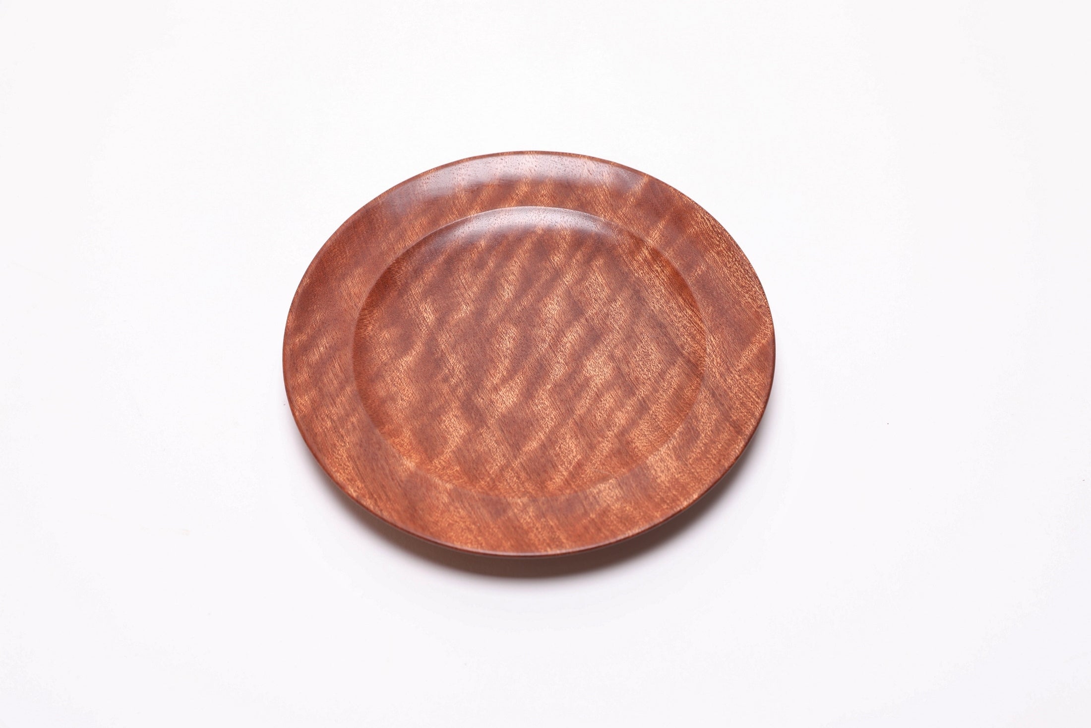 Pommele ribbon sapele wooden ring dish, top view rotated 45°, highlighting pommele figure across full surface
