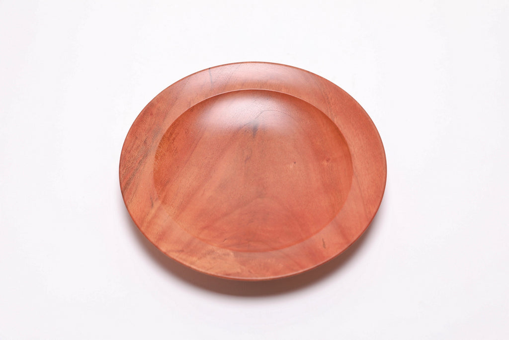 Wild black cherry wooden ring dish, top view at 0°, showing deep pink-orange tones and natural grain