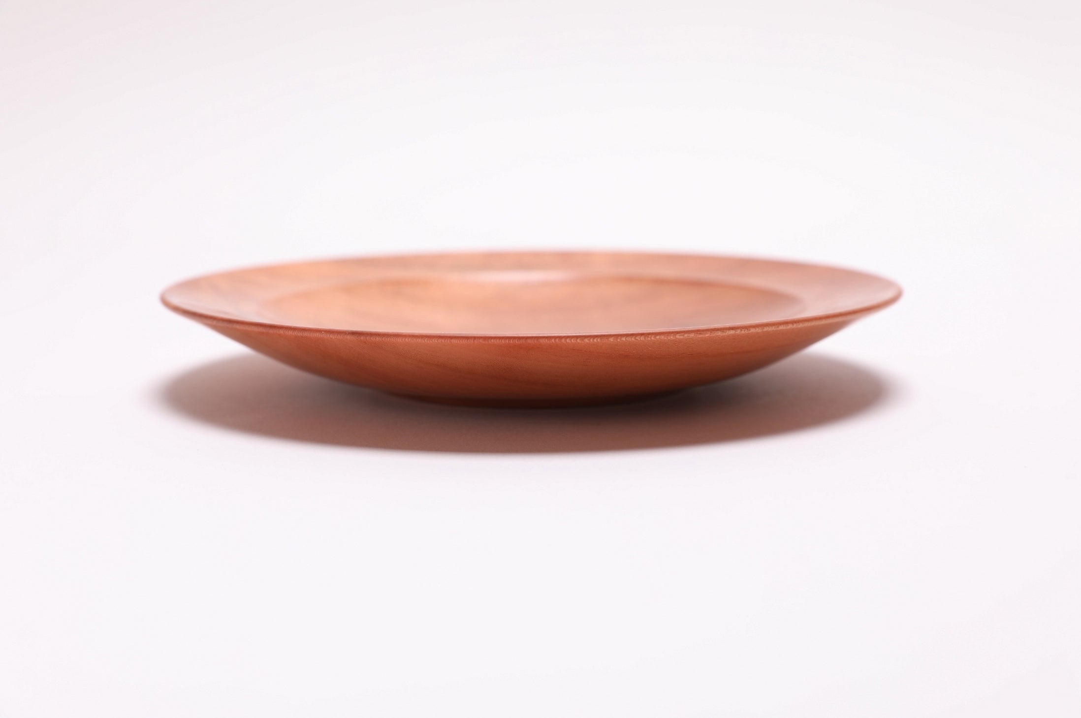 Wild black cherry wooden ring dish, side view showing rounded rim and natural oil finish