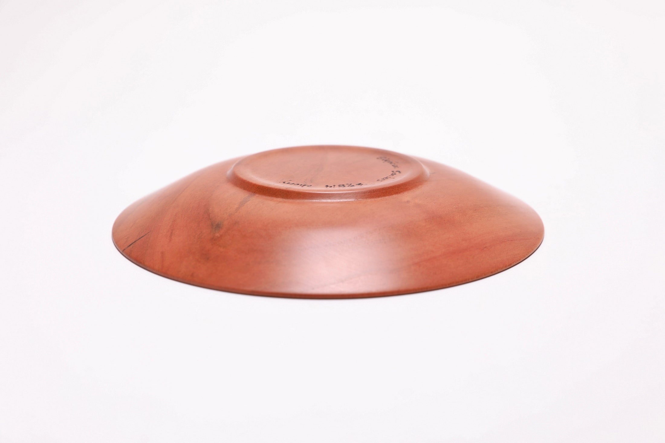Wild black cherry wooden ring dish, bottom view showing raised foot and natural finish
