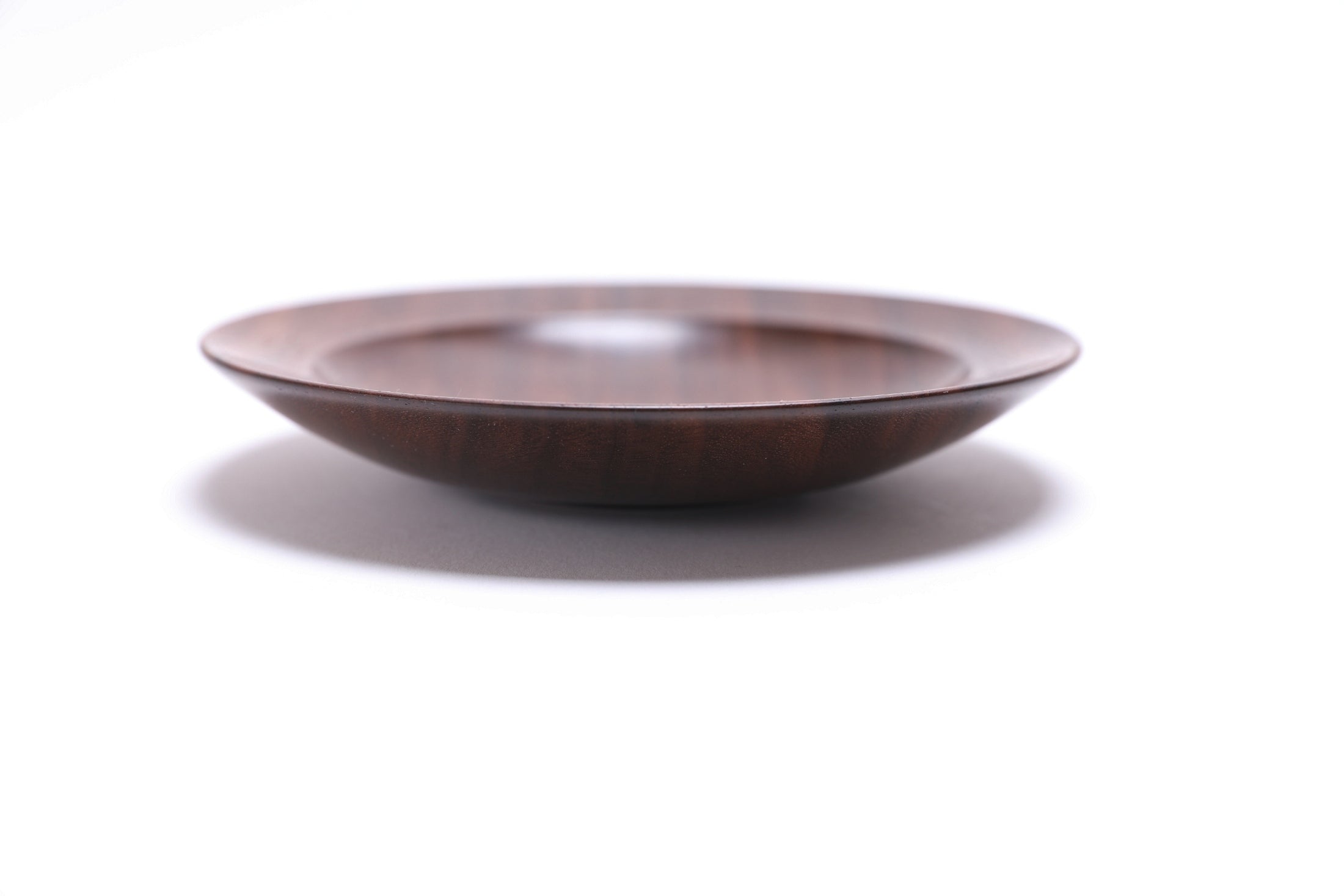 Quartersawn wild black walnut wooden ring dish, side view at 0°, showing 1" depth, curved taper, and raised foot