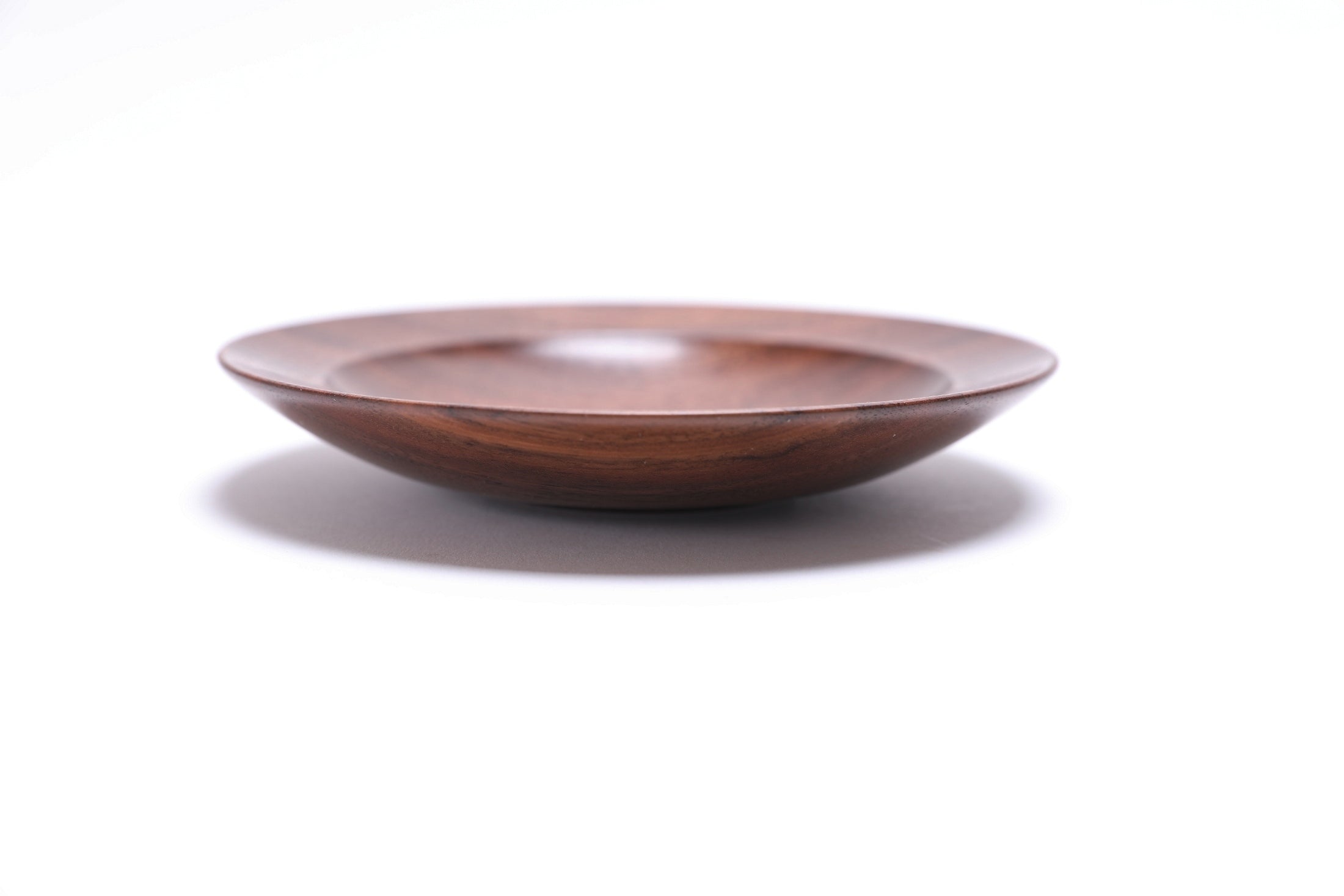 Quartersawn wild black walnut wooden ring dish, side view at 270°, raised foot and rich walnut color visible