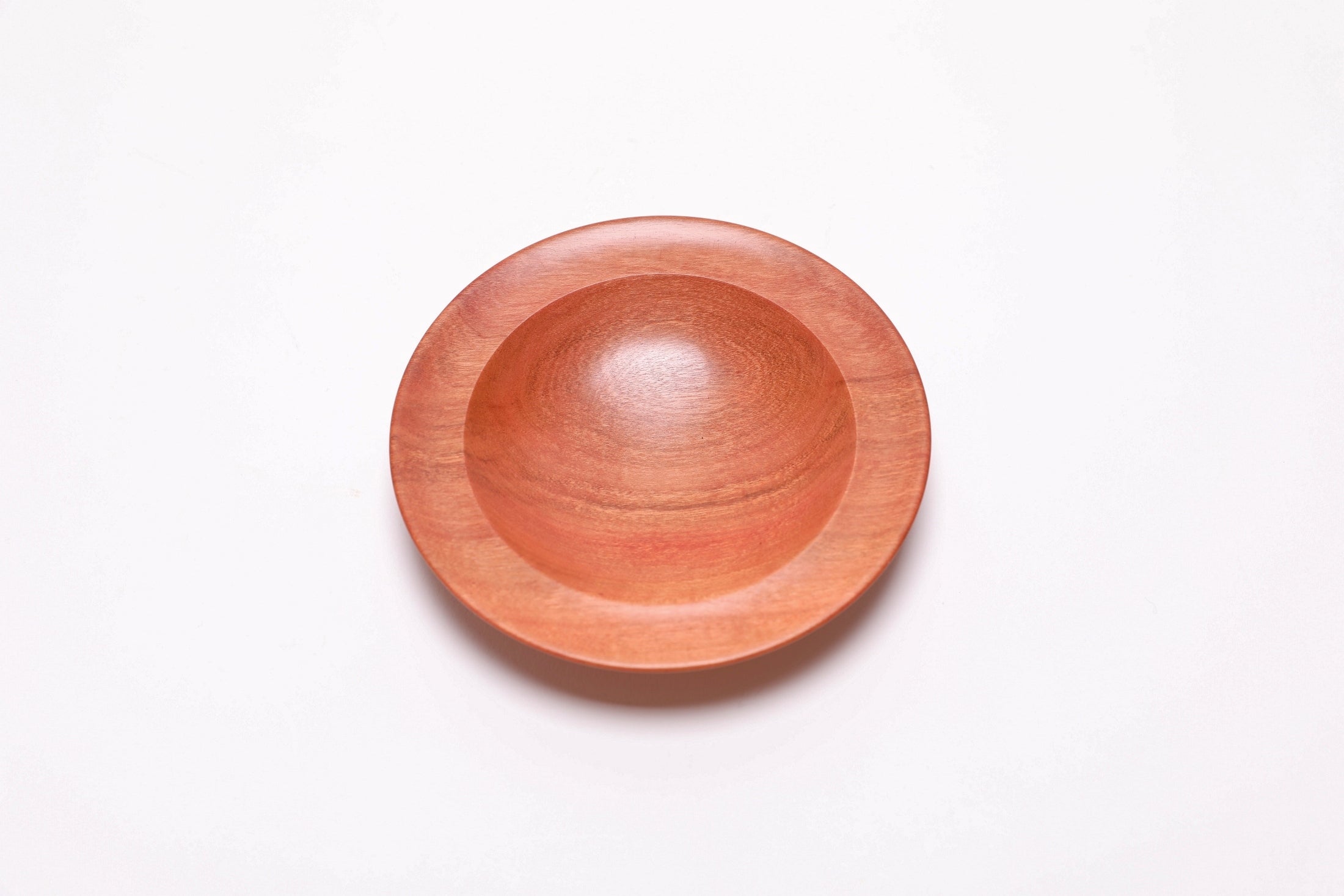 Wild black cherry wooden ring dish, top view at 0°, showing bullseye figure and red highlights