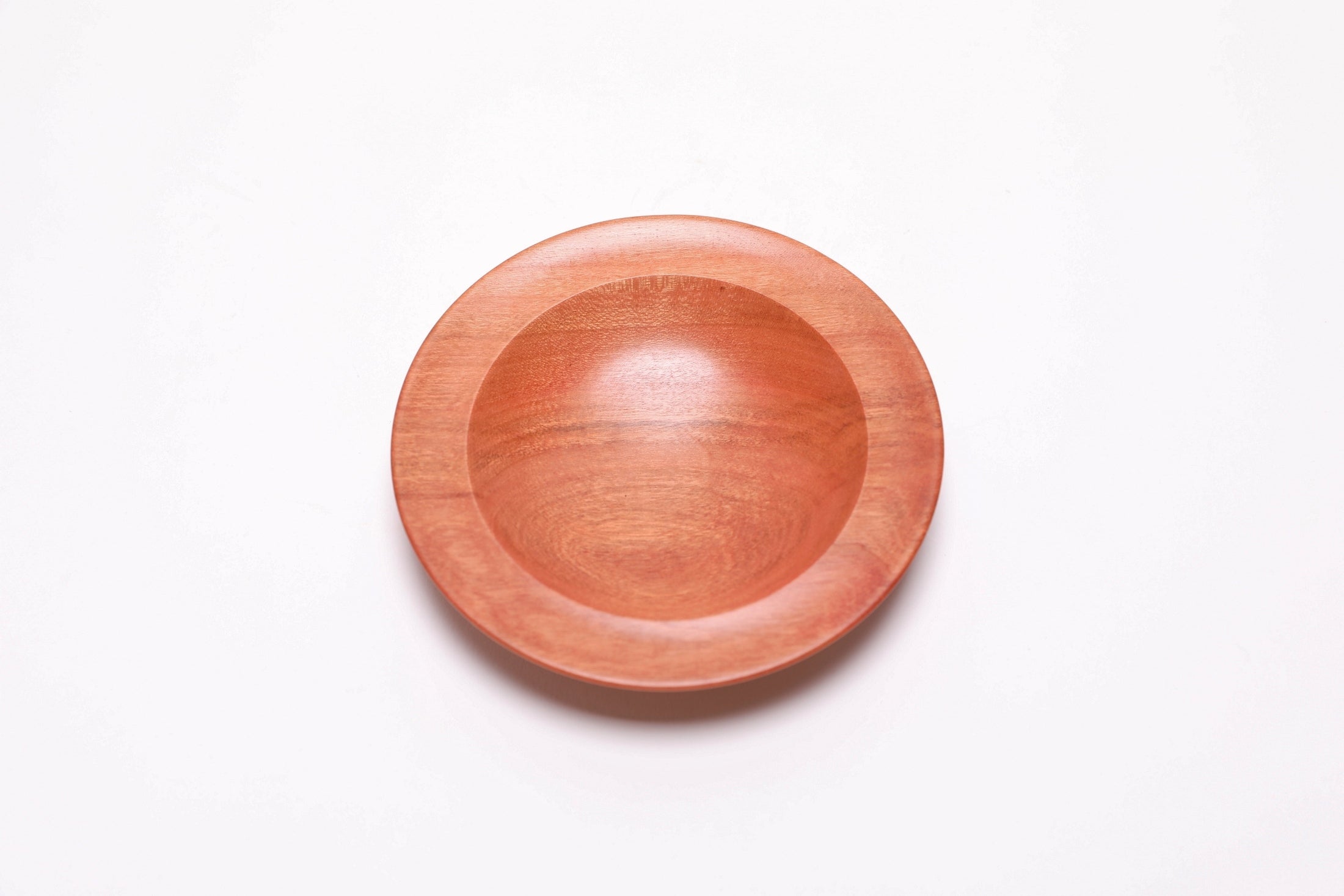 Wild black cherry wooden ring dish, top view at 180°, oblong bullseye figure and curved undercut rim