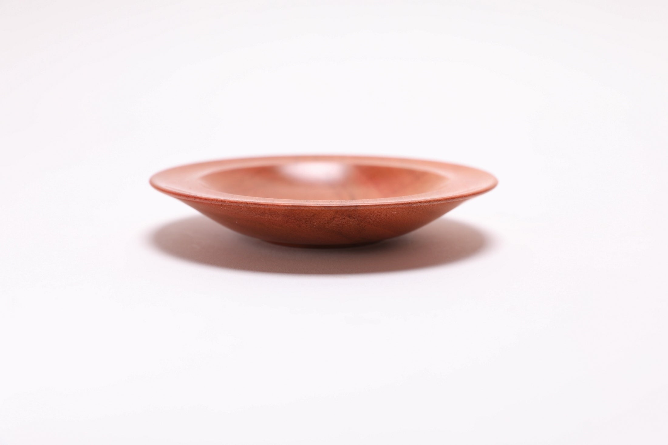 Wild black cherry wooden ring dish, side view at 90°, rounded rim and handcrafted profile