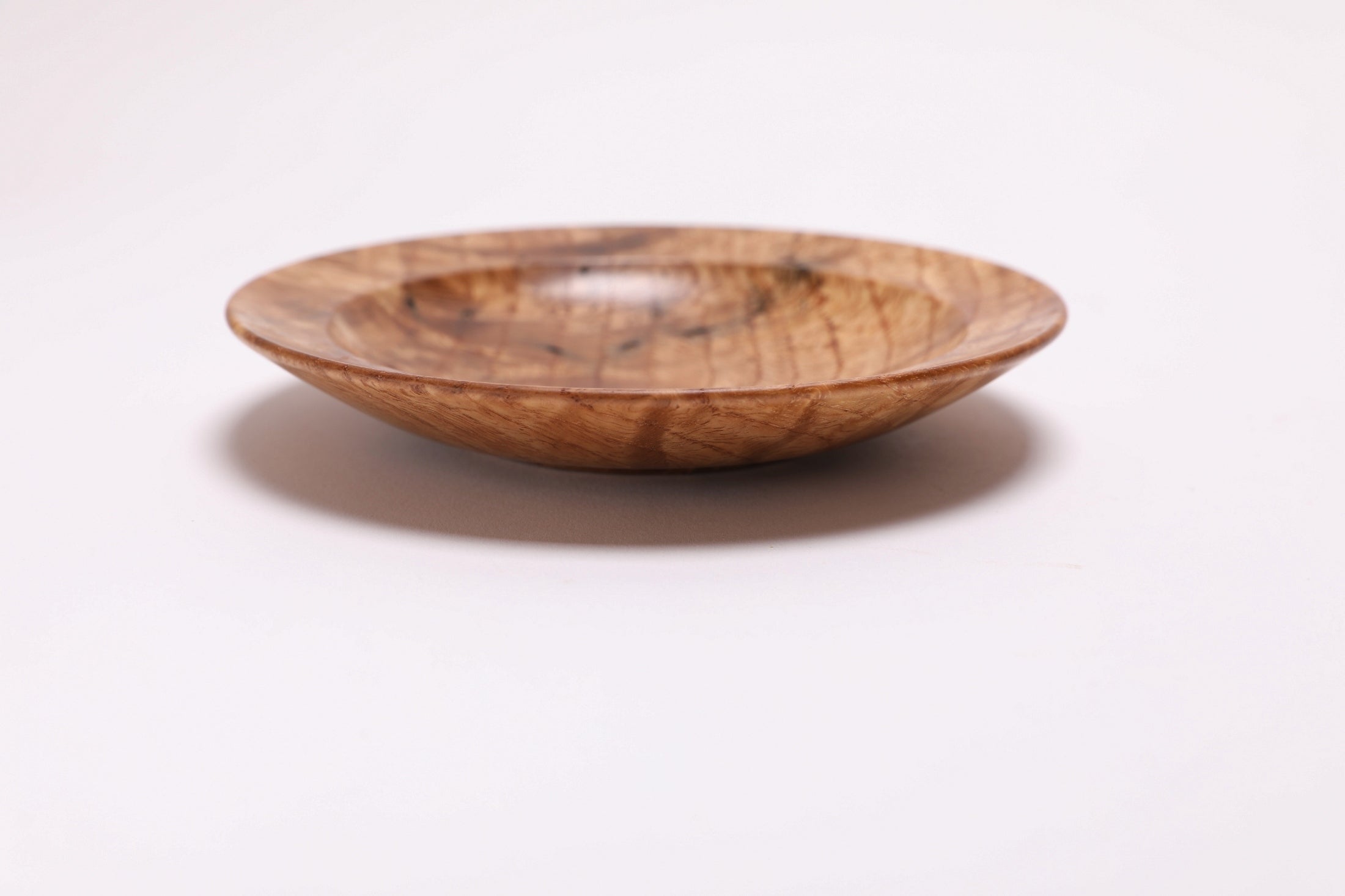 Wormy white oak crotch burl wooden bowl, side view at 180°, worm hole character and burl figure visible