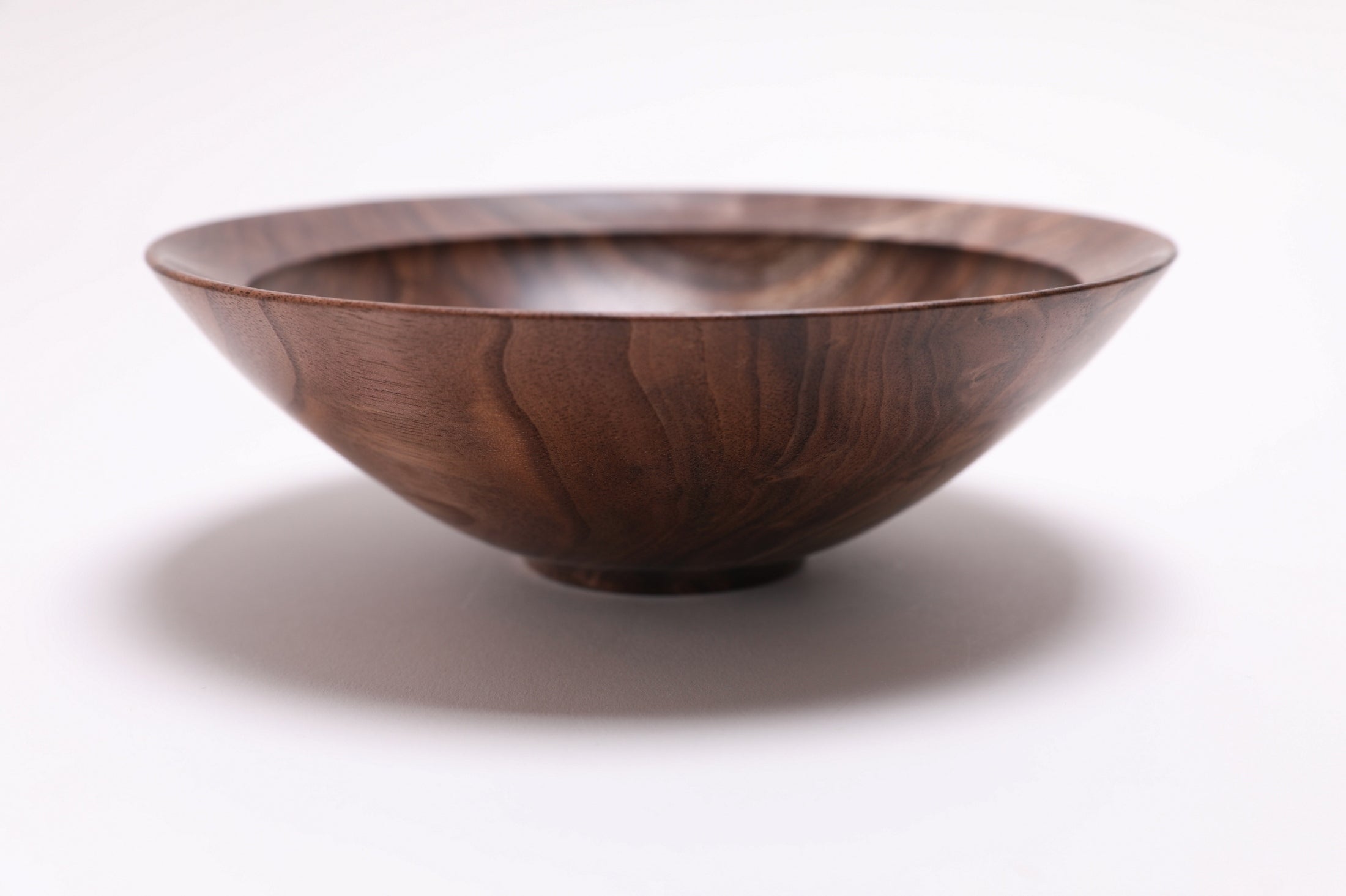 Wild black walnut crotch burl wooden bowl, side view at 90°, rounded undercut rim and handcrafted profile