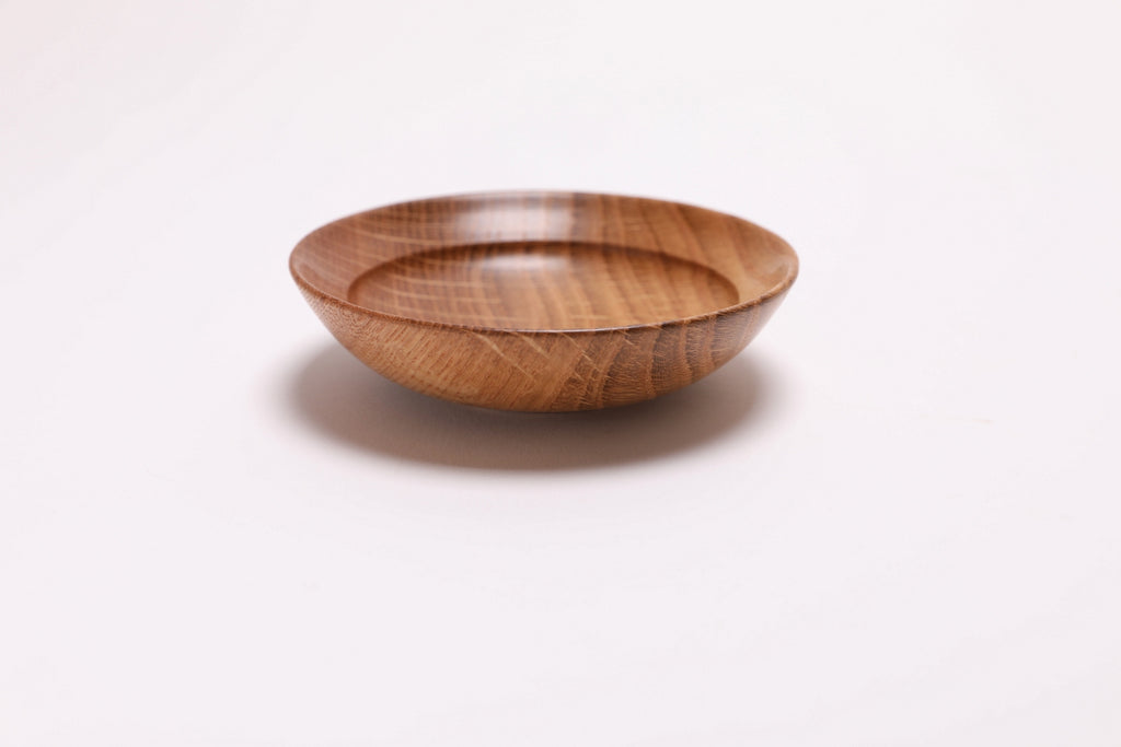 Quartersawn white oak wooden ring dish, side view at 270°, small raised foot and rich oak color visible