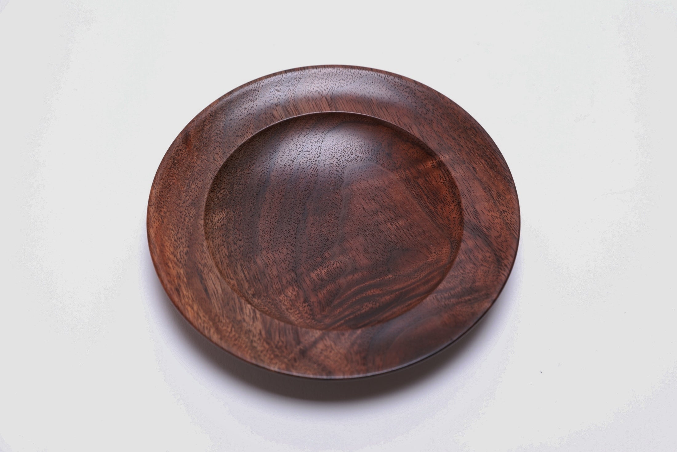 Black walnut crotch burl wooden jewelry dish, top view at 180°, rich chocolate and amber coloration across full surface