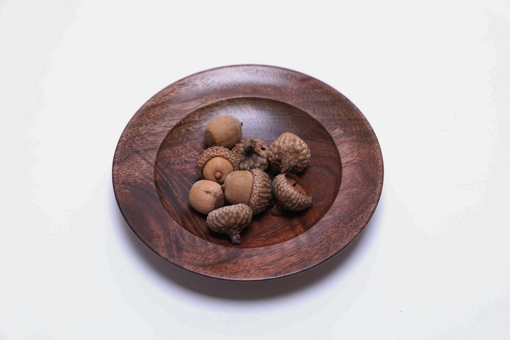 Black walnut crotch burl wooden jewelry dish shown with acorns for scale — acorns not included