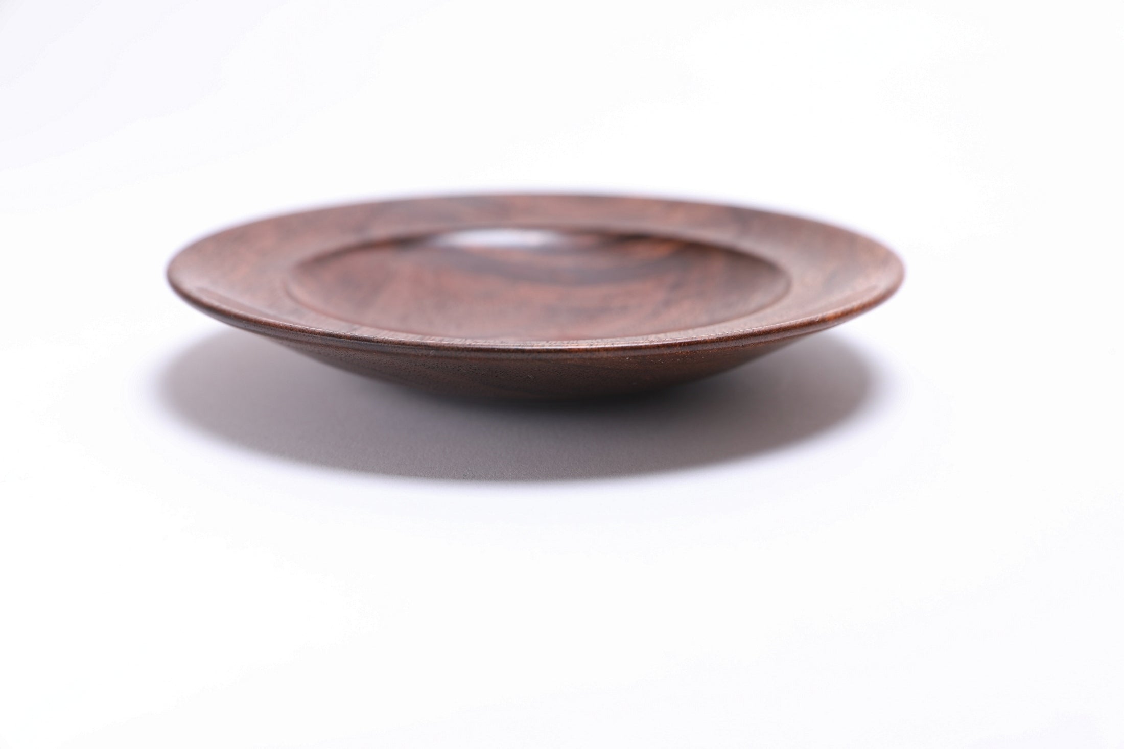 Black walnut crotch burl wooden jewelry dish, side view at 0°, showing ⅞" depth, curved taper, and raised foot