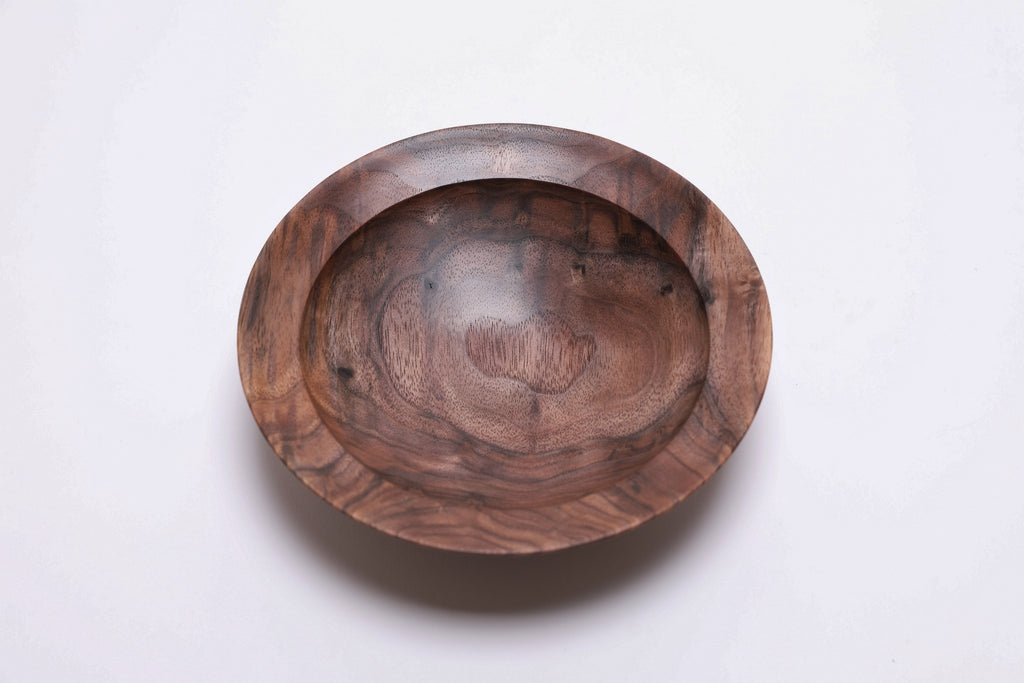 Curly wild black walnut wooden bowl, top view at 0°, showing curly growth rings and bud scars
