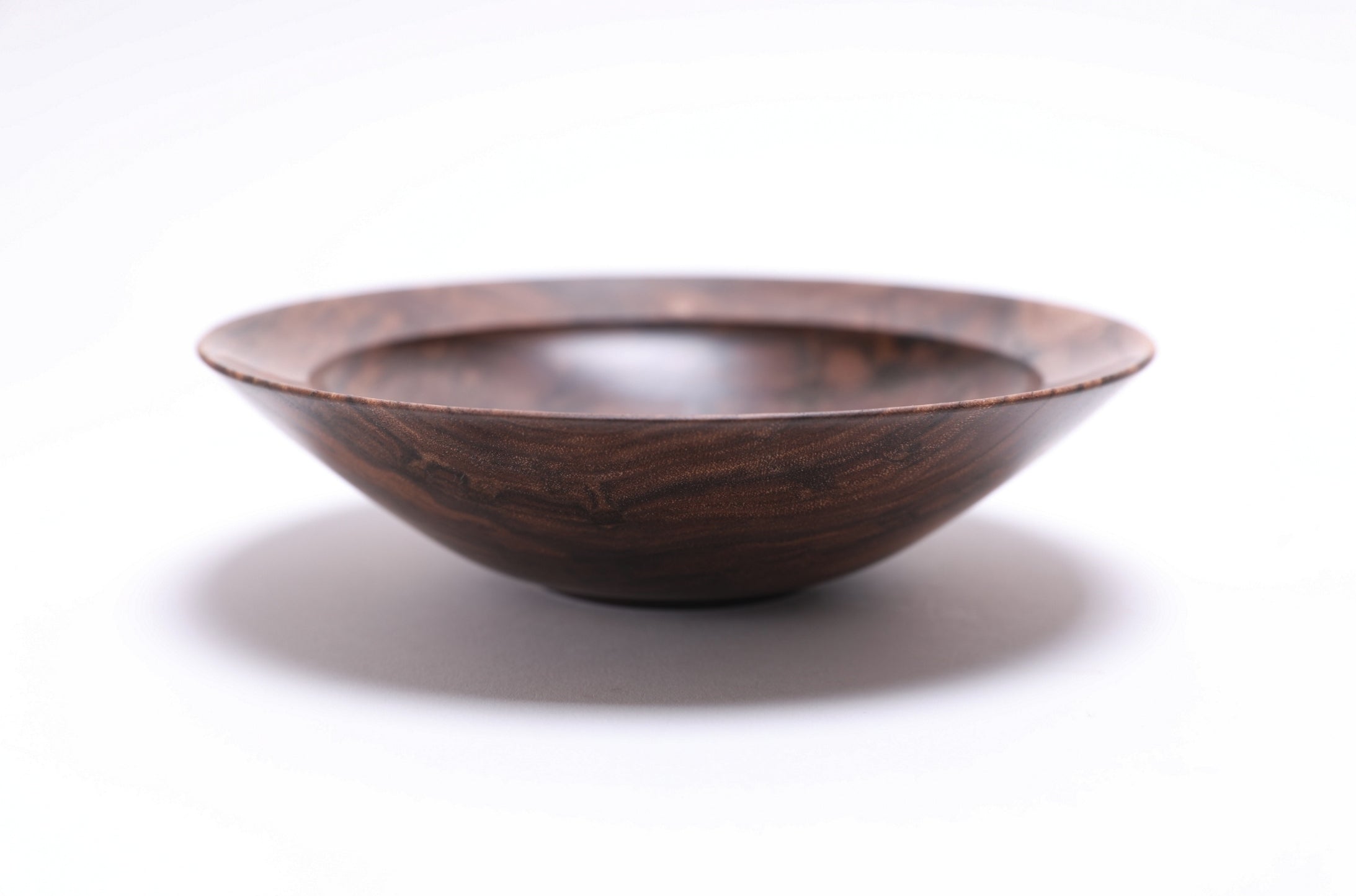 Curly wild black walnut wooden bowl, side view at 0°, showing 1¾" depth, curved taper, and raised foot