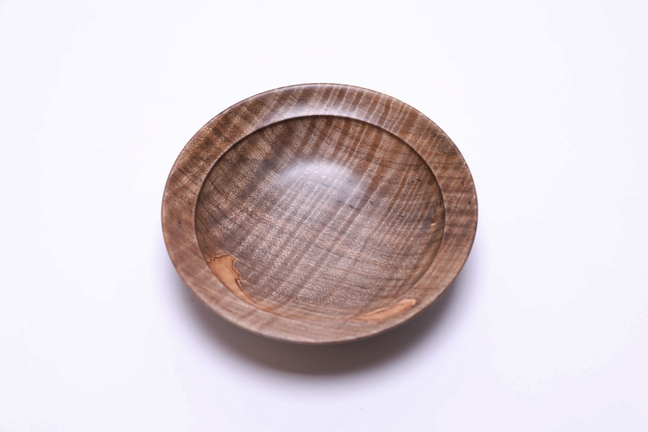 Spalted tiger ambrosia maple wooden bowl, top view at 225°, salmon ambrosia patch and amber gray tones