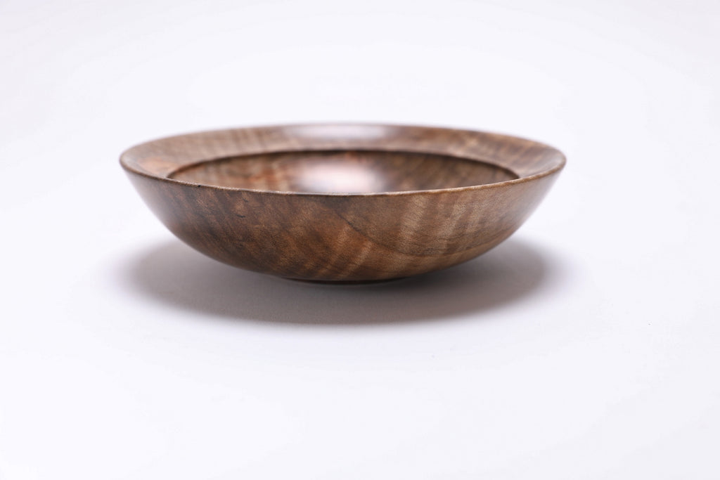 Spalted tiger ambrosia maple wooden bowl, side view at 0°, showing depth, curved taper, and raised foot