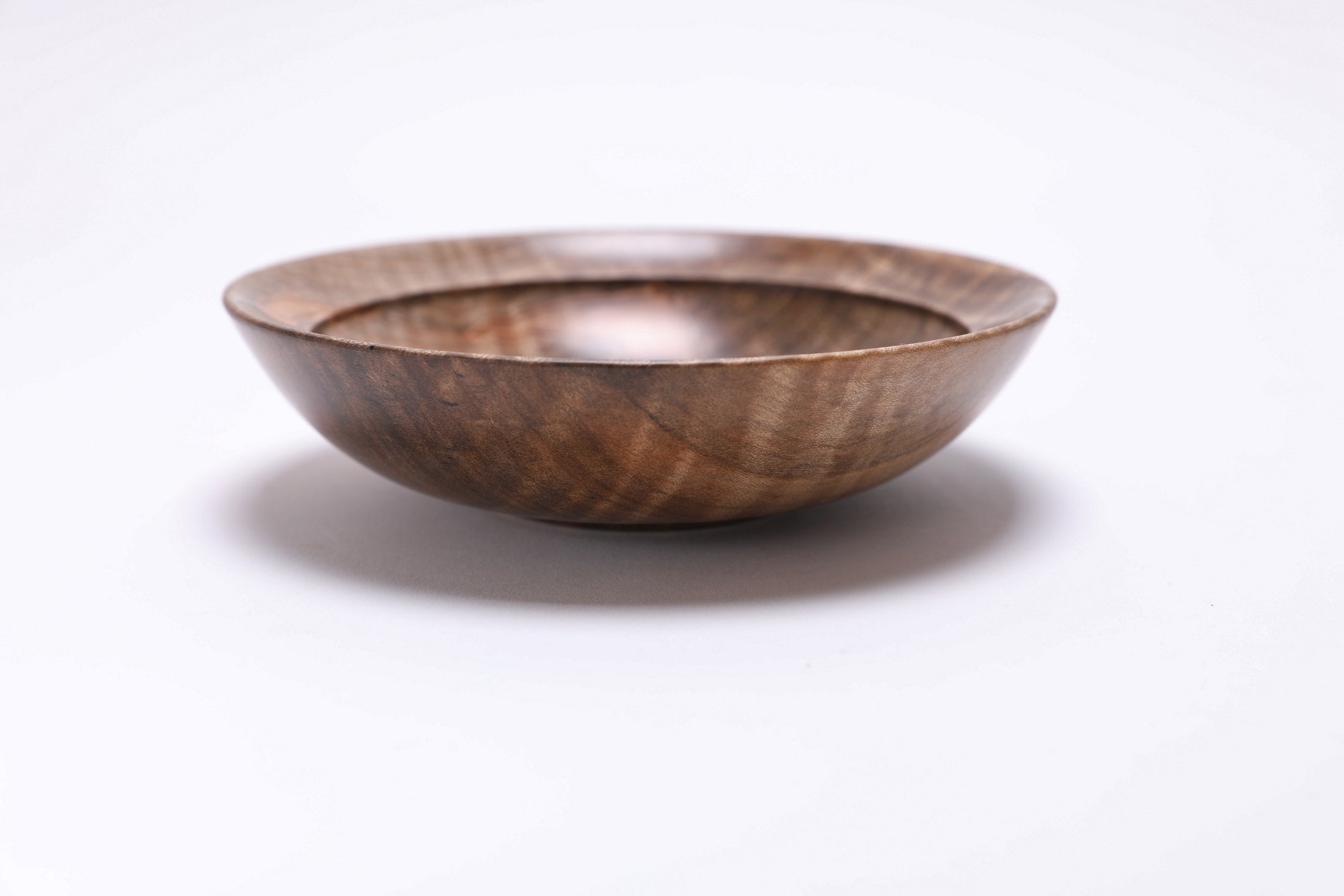Spalted tiger ambrosia maple wooden bowl, side view at 0°, showing depth, curved taper, and raised foot