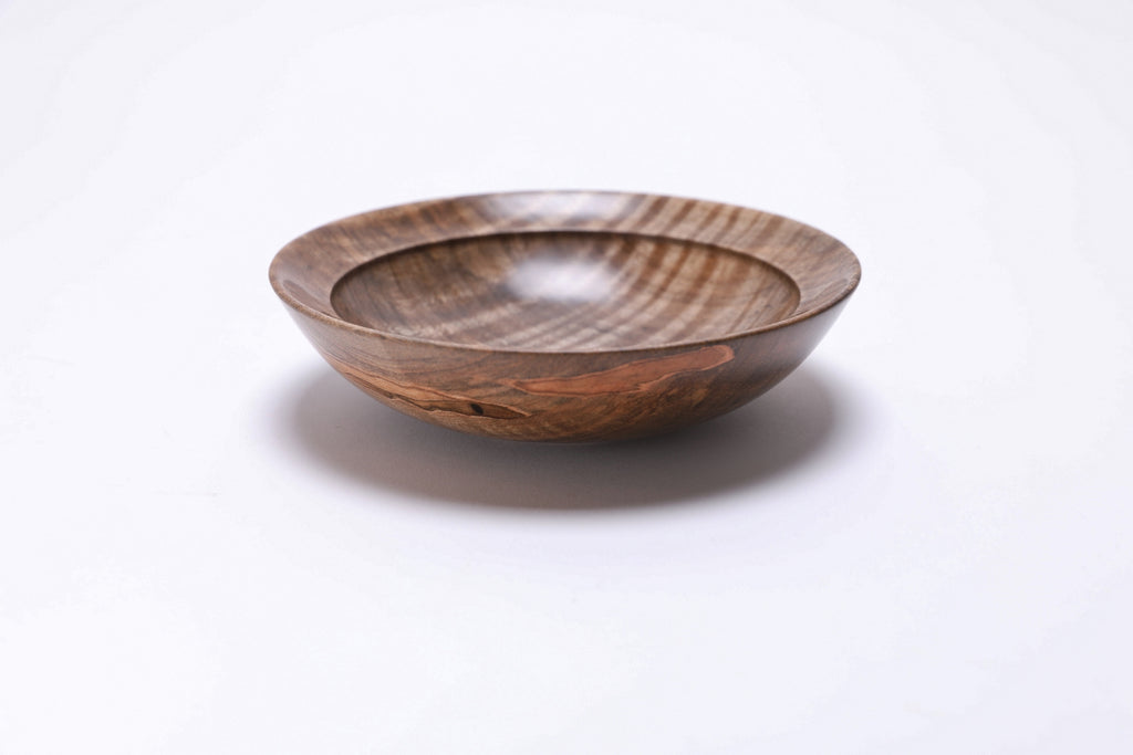 Spalted tiger ambrosia maple wooden bowl, side view at 270°, raised foot and amber gray coloration visible