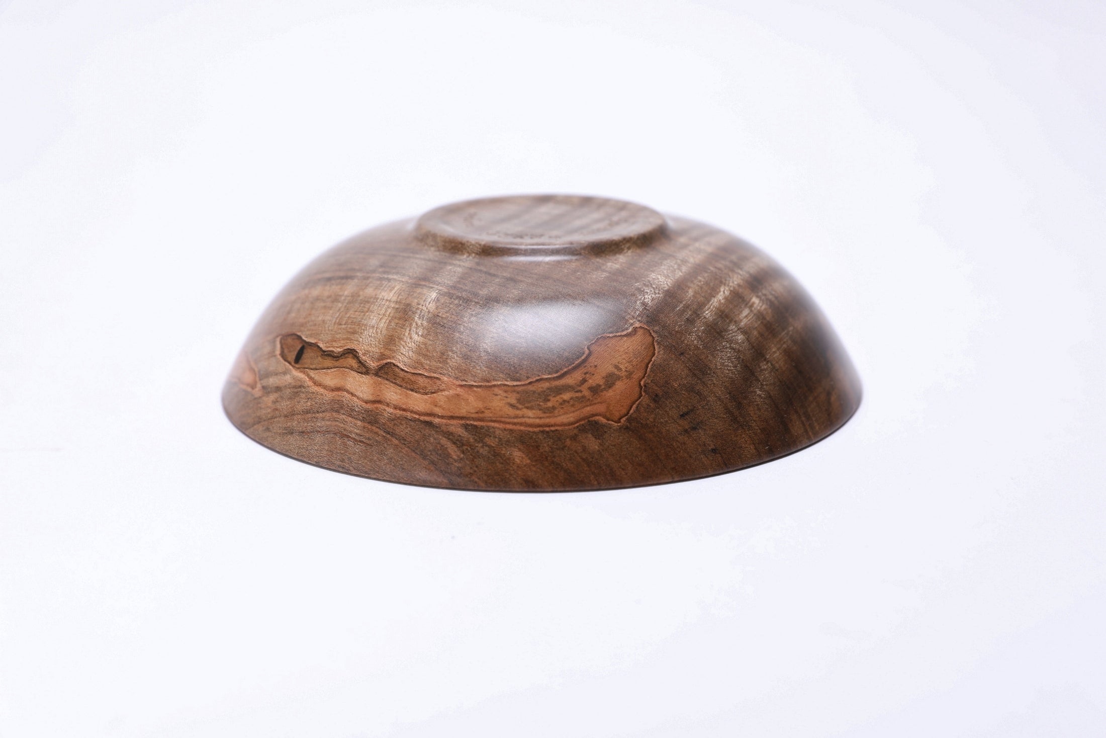 Spalted tiger ambrosia maple wooden bowl, bottom view showing raised foot and natural finish