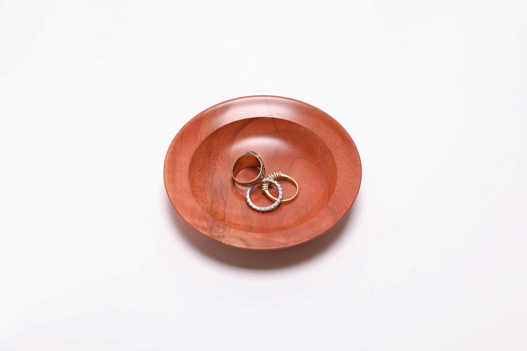 Wild black cherry wooden ring dish with three rings for scale, 4 5/8 x 7/8 inches