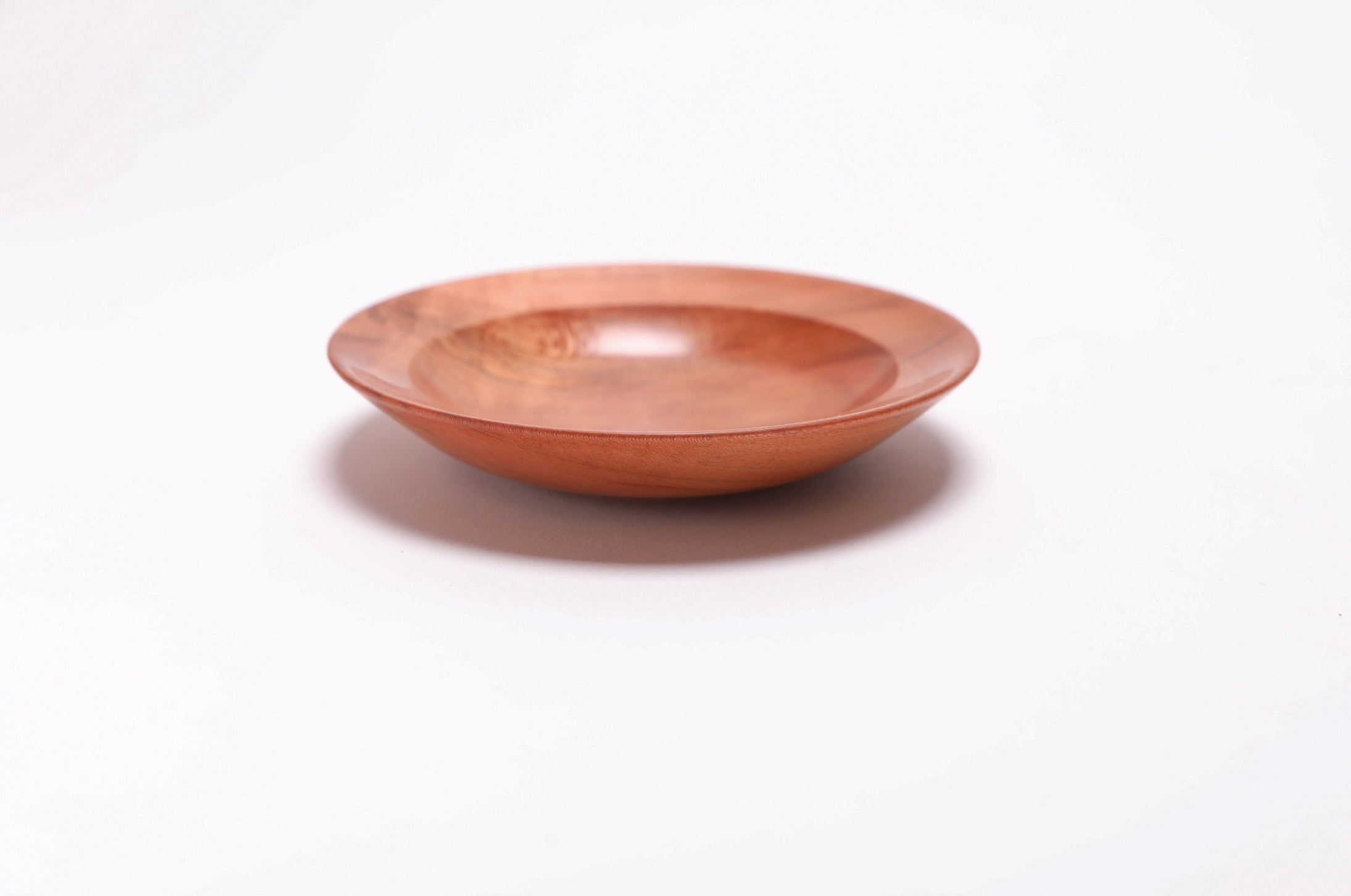 Wild black cherry wooden ring dish, angled side view, 0°, curved taper and raised foot