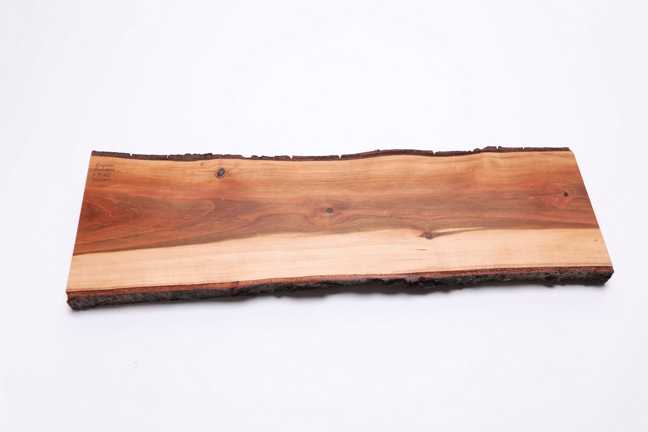 Bottom view of wild black cherry charcuterie board showing natural wood surface and thickness