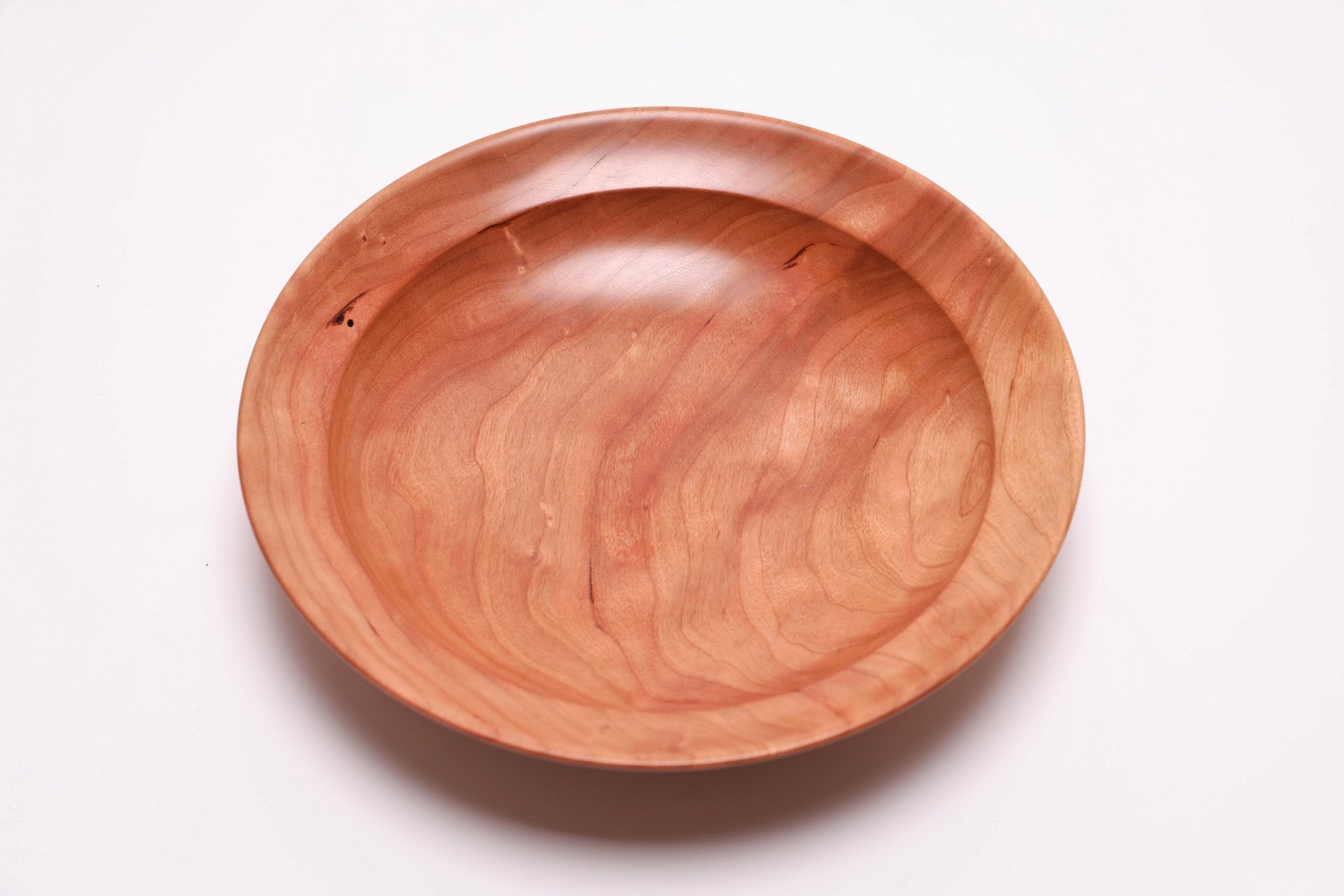 Wild black cherry wooden bowl top view 90 degrees, burgundy streaks and wide growth rings