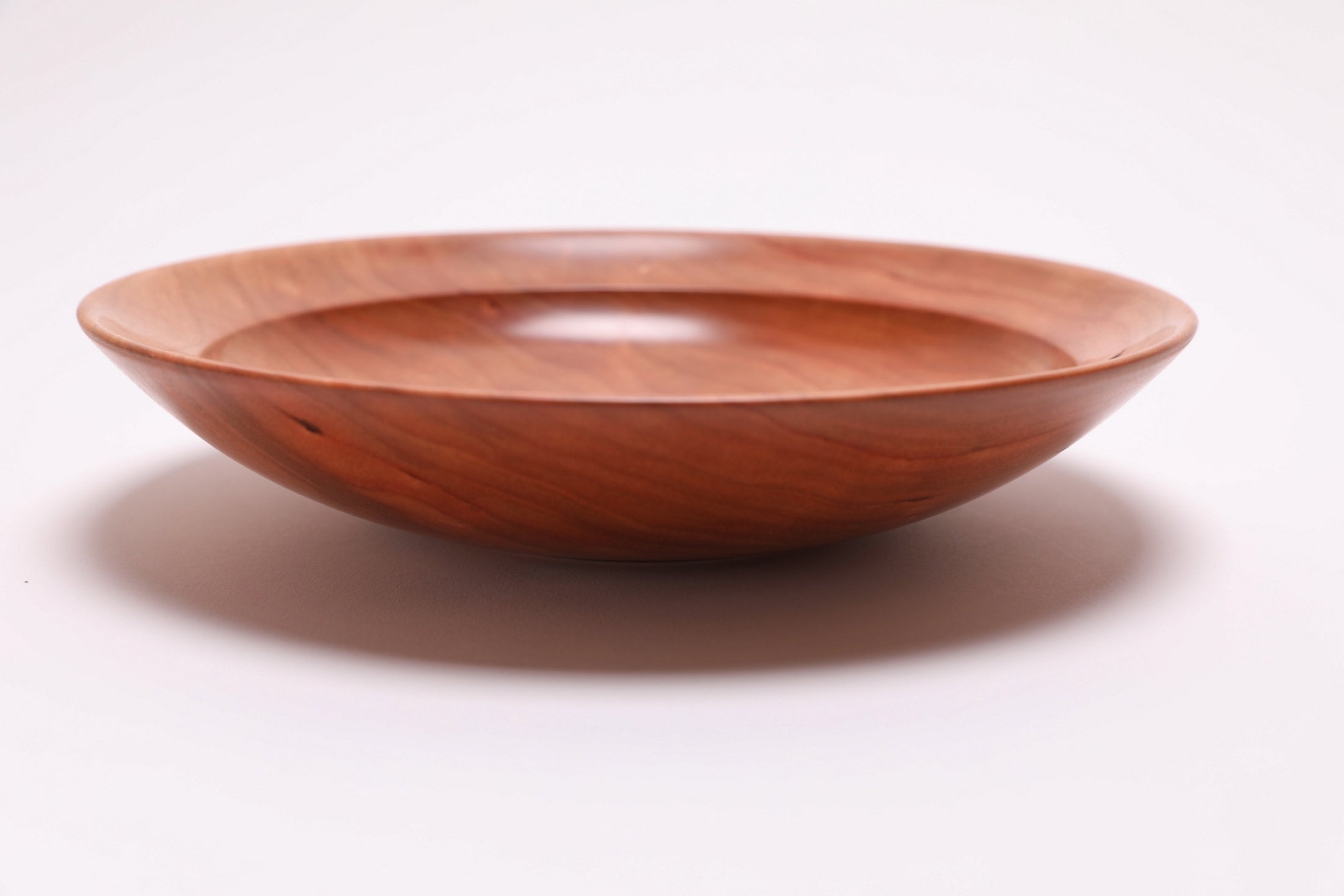 Wild black cherry wooden bowl side view 90 degrees, raised foot and rim profile detail