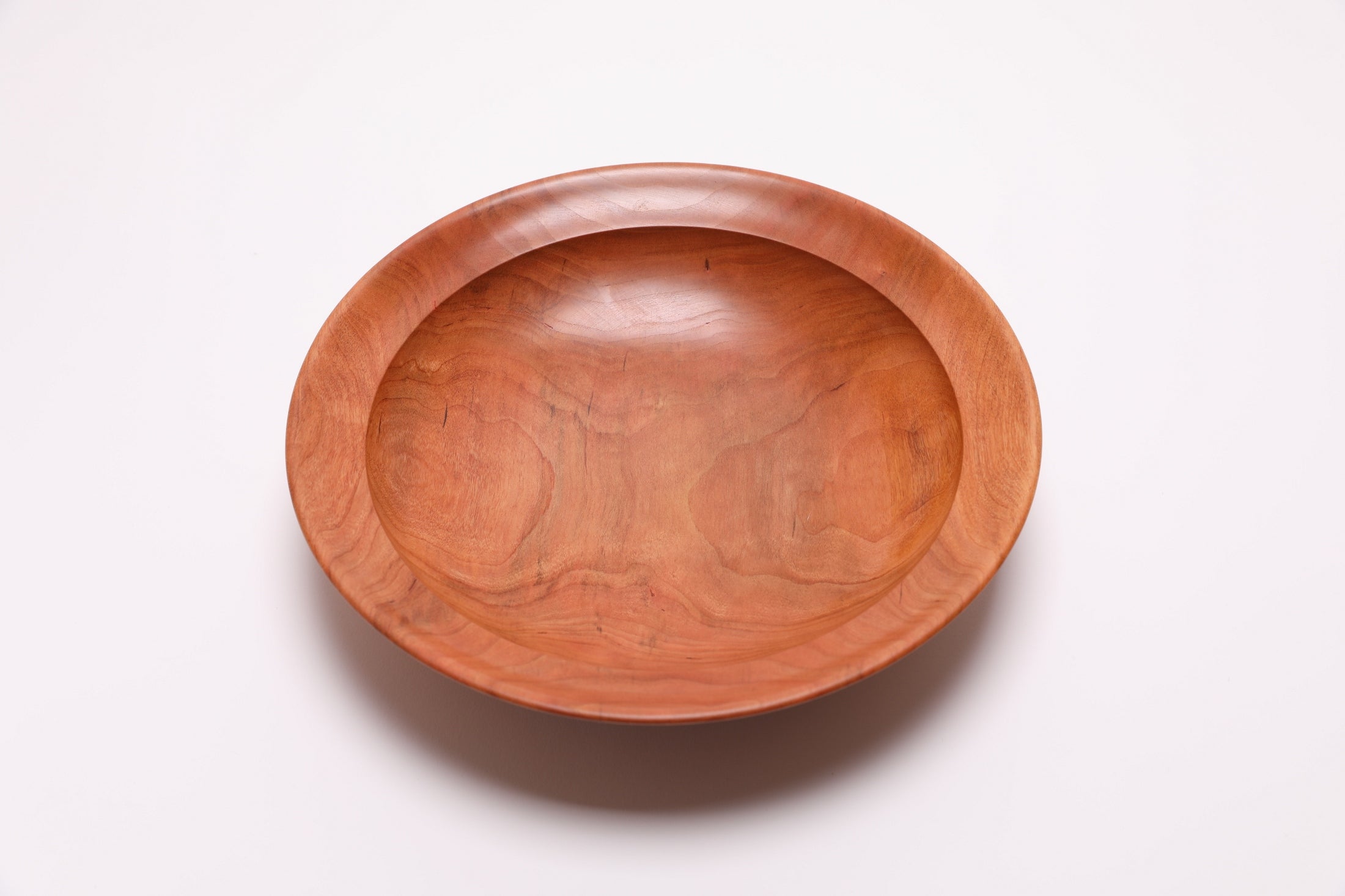 Wild black cherry wooden bowl top view rotated 90°, showing rich grain from 200-year-old cherry tree