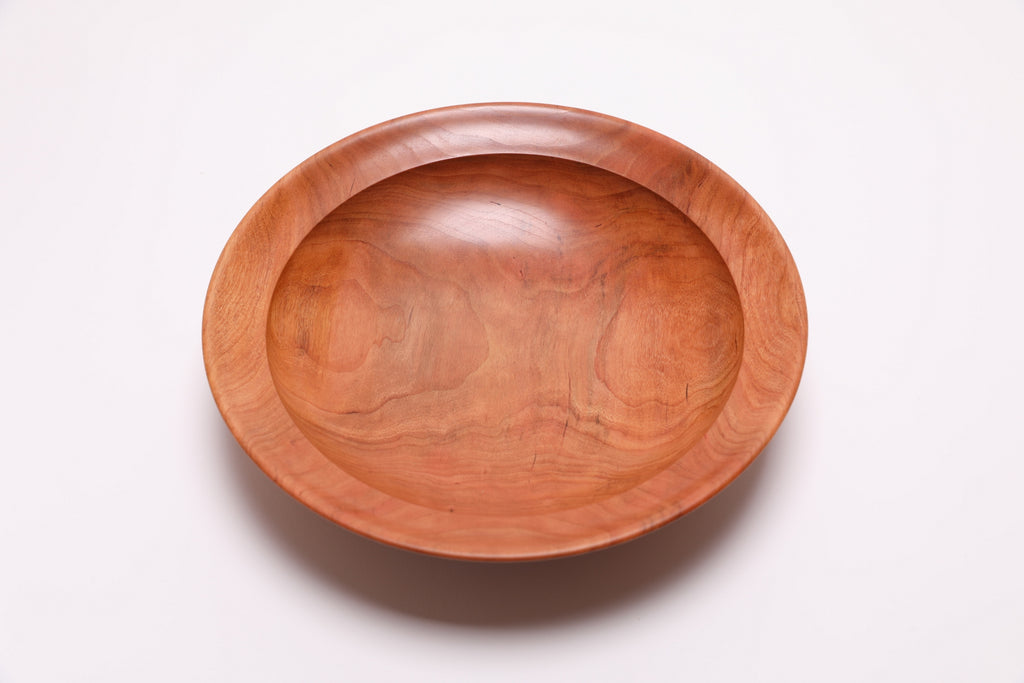 Wild black cherry wooden bowl top view rotated 270°, natural oil finish and undercut rim visible