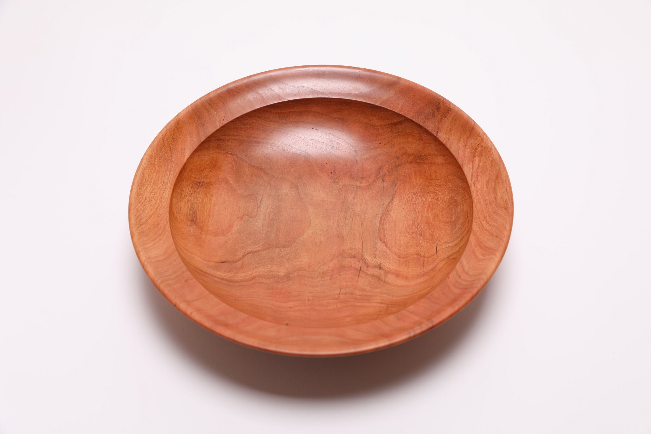 Wild black cherry wooden bowl top view rotated 270°, natural oil finish and undercut rim visible