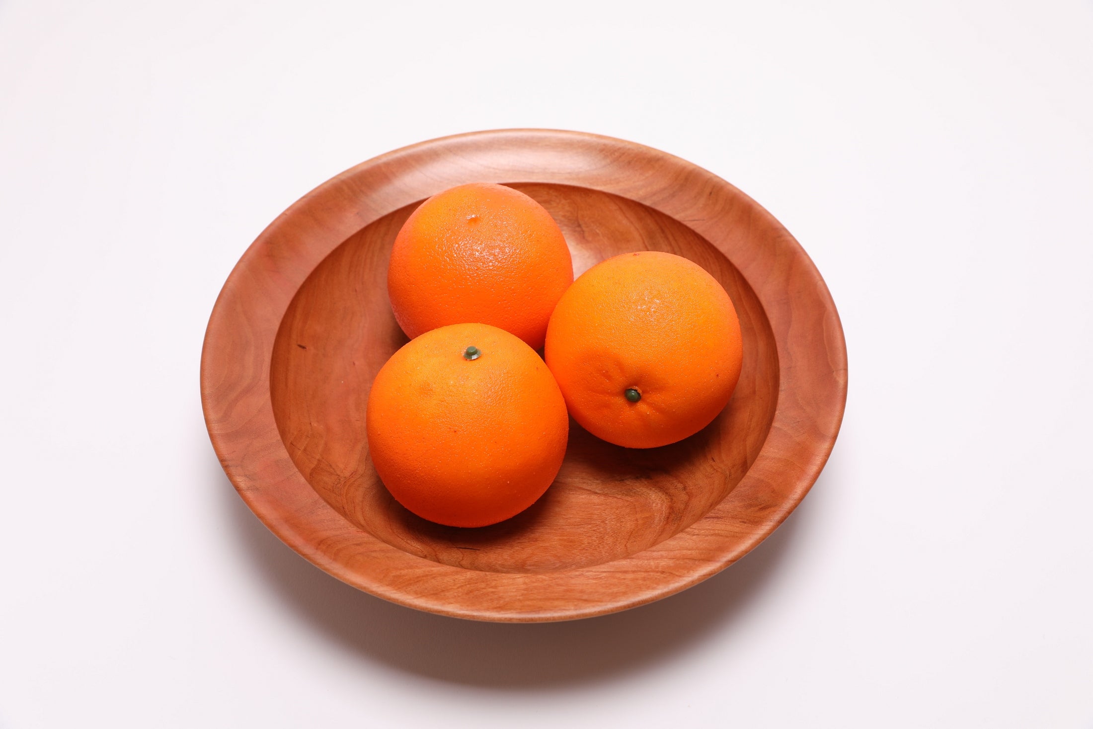 Wild black cherry wooden bowl shown with three oranges for scale – 10 1/8" x 2 1/4" handcrafted wood bowl