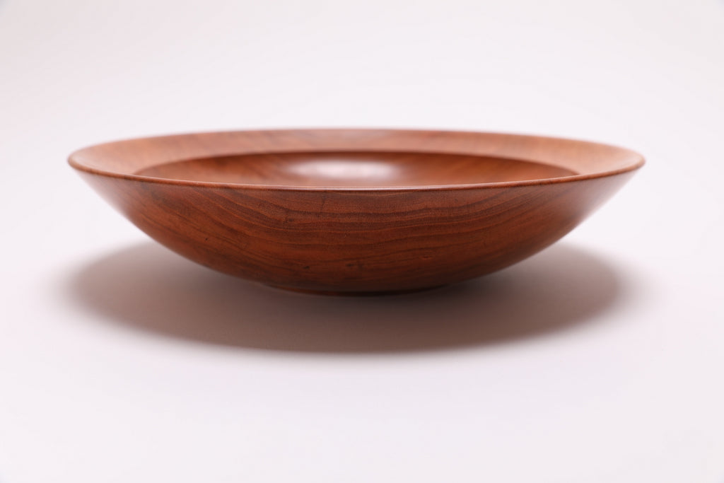 Wild black cherry wooden bowl side view rotated 90°, rich orange-pink grain and food-safe oil finish