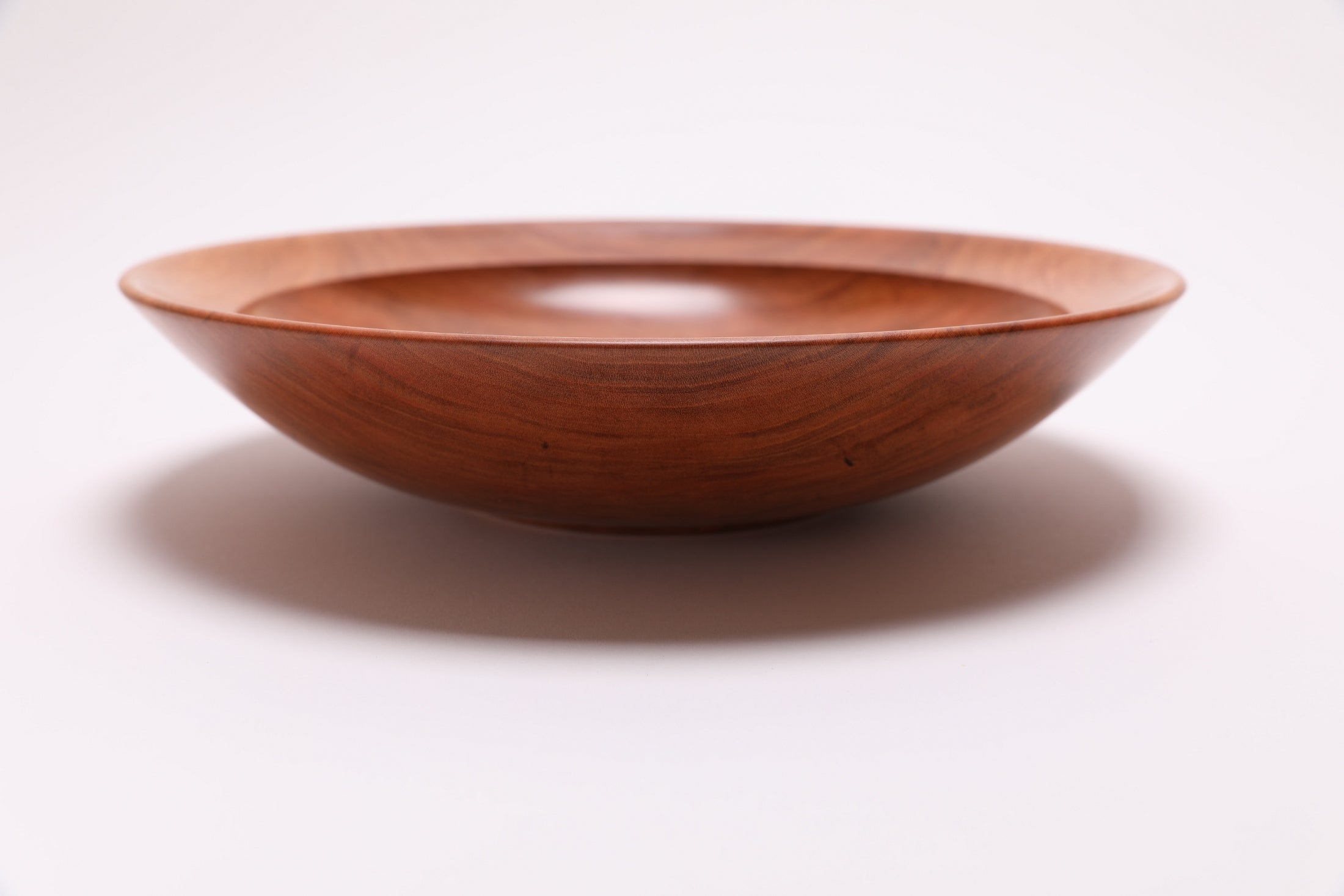 Wild black cherry wooden bowl side view rotated 270°, undercut rim and natural wood grain
