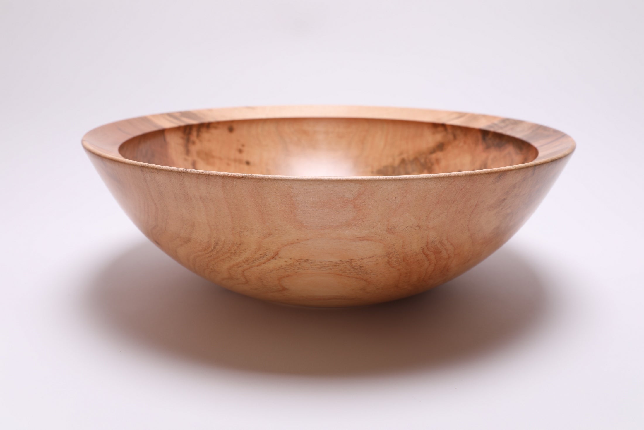 Large sugar maple bowl side view rotated 180°, curved taper and raised foot detail