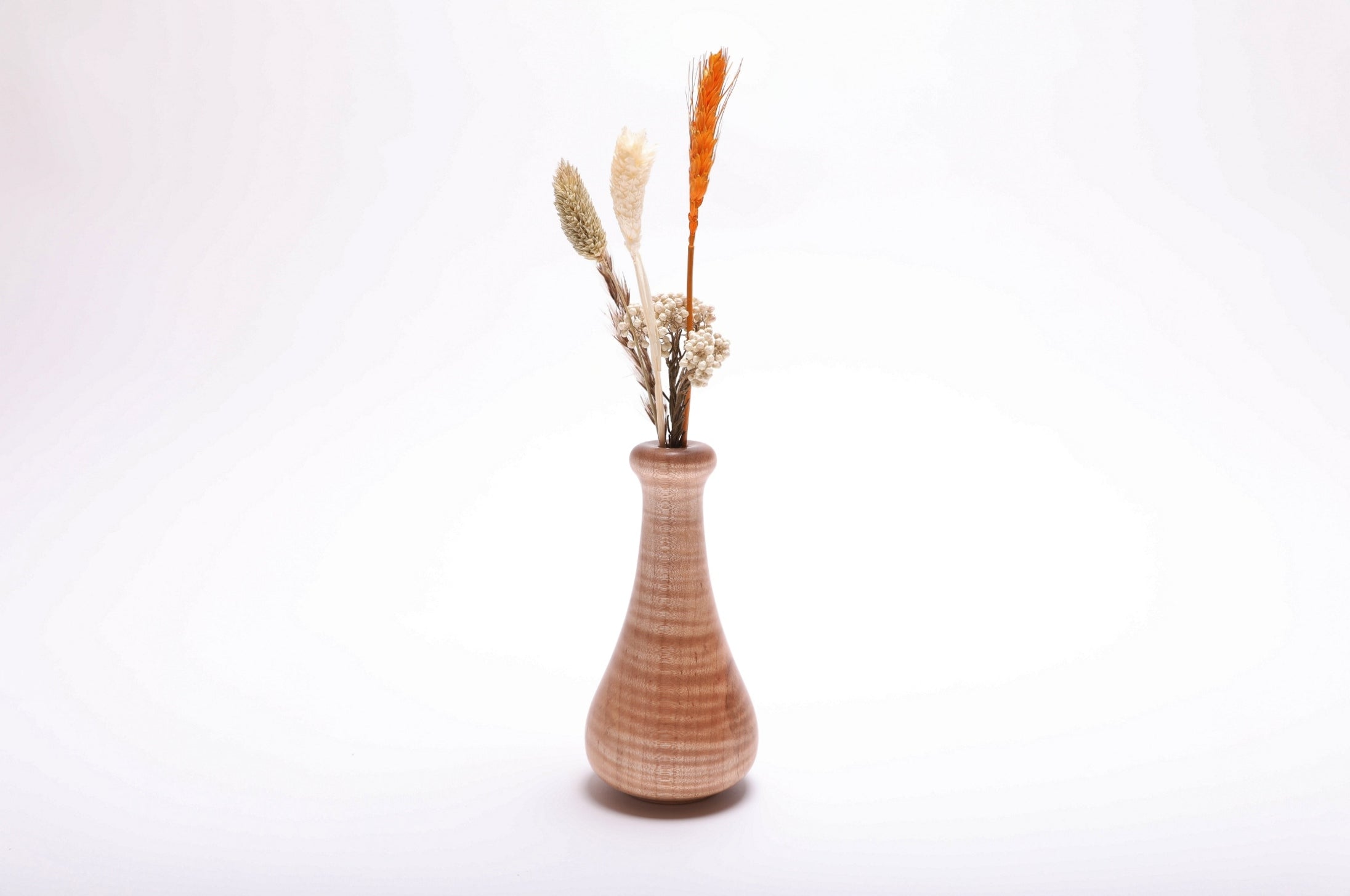 Handcrafted tiger maple weed pot with dried flowers (not included), side view – chatoyant figure and natural oil finish, 2 3/4" x 5 1/4"