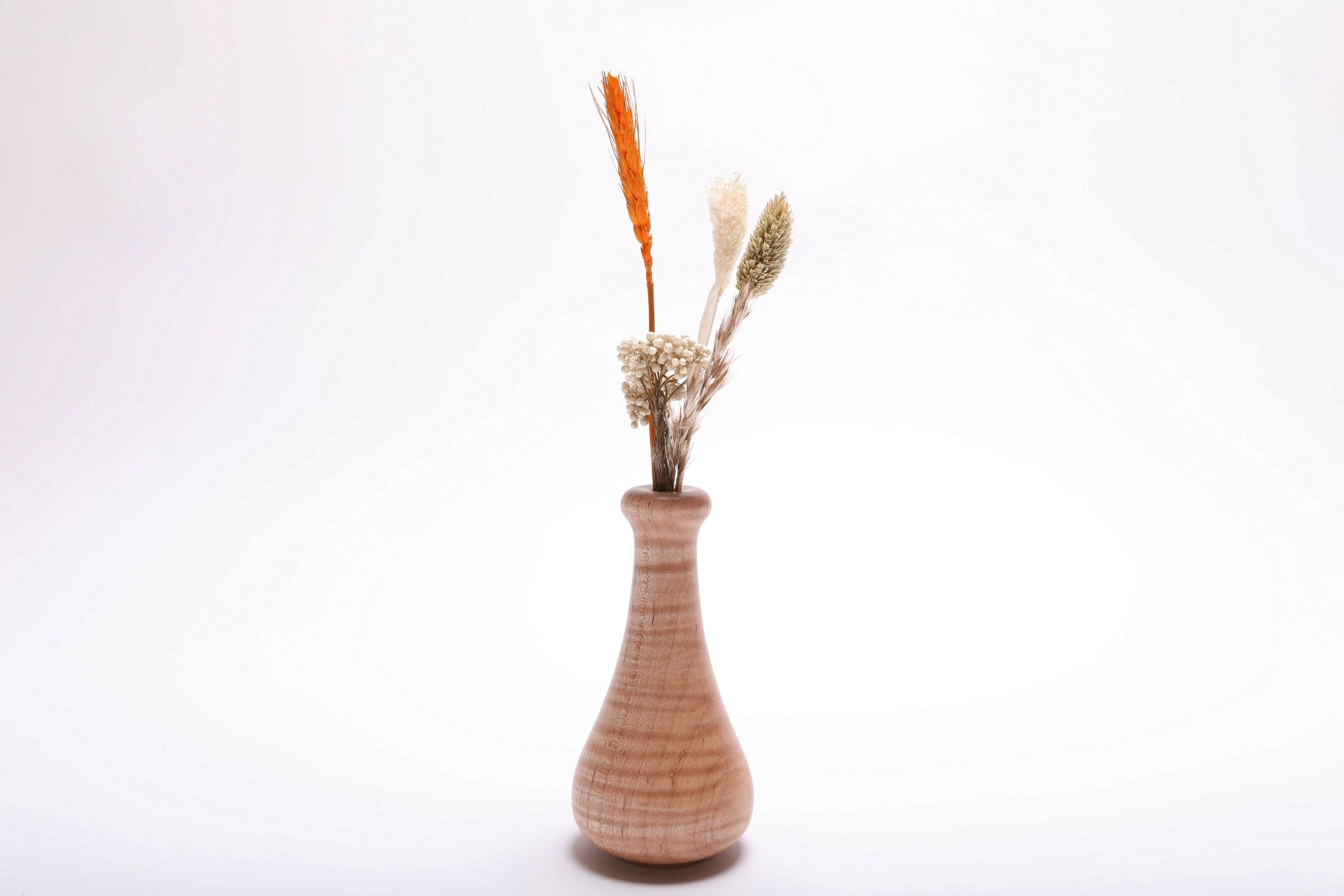 Tiger maple weed pot with dried flowers (not included), side view rotated 135° – rich curly grain and food-safe oil finish
