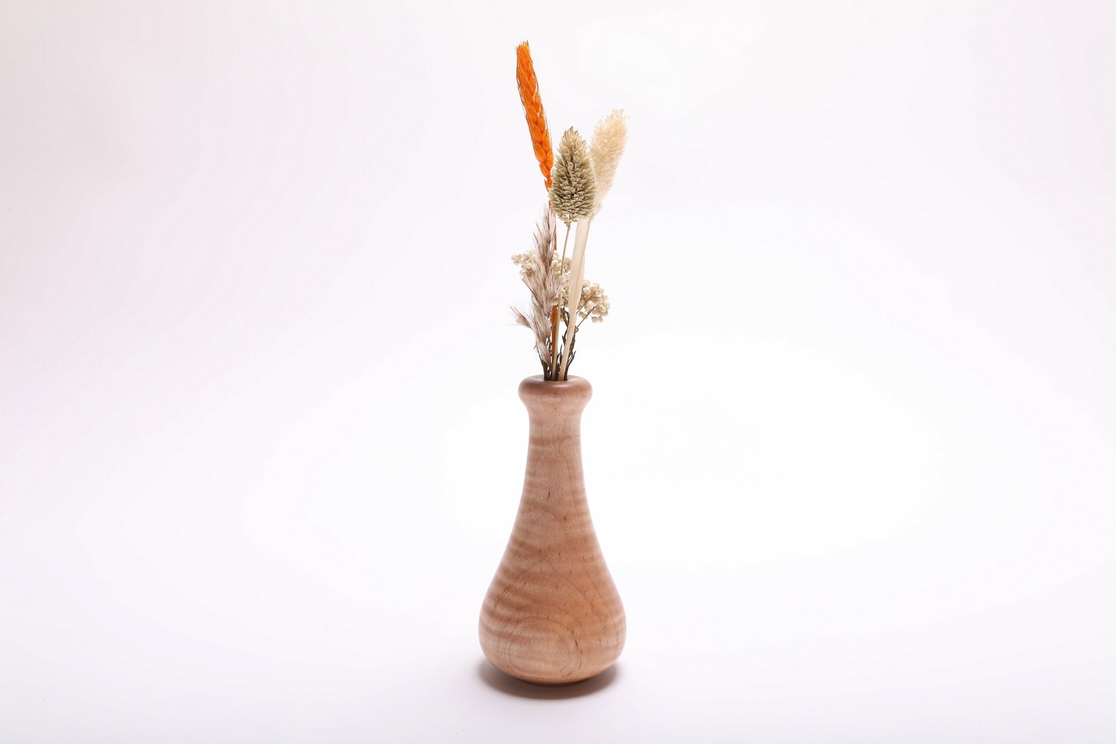 Tiger maple weed pot with dried flowers (not included), side view rotated 180° – full figure visible across turned wood surface