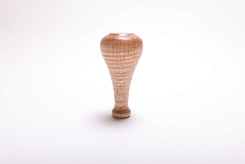 Bottom view of handcrafted tiger maple weed pot showing food-safe oil finish and turned base