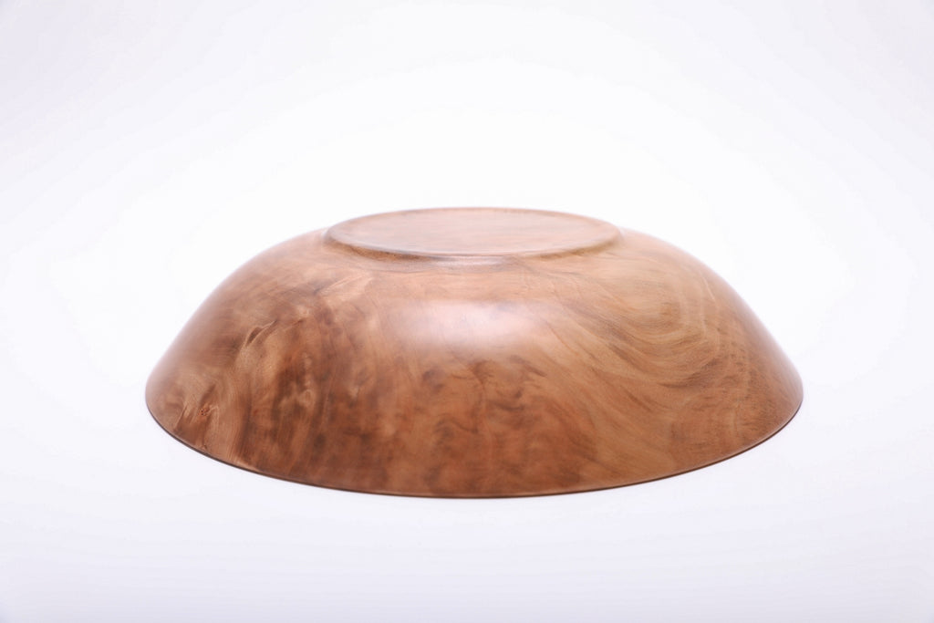Bottom view of handcrafted sweet gum wooden bowl showing raised foot and food-safe oil finish