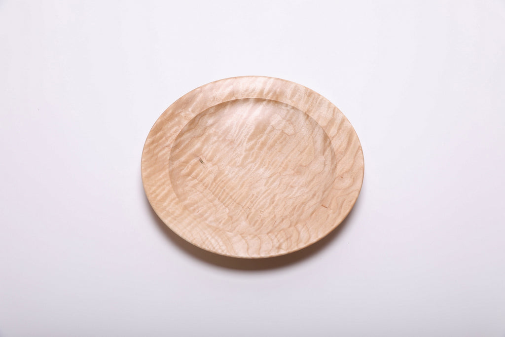 Curly quilted maple shallow bowl top view rotated 45°, dense quilt figure and amber growth ring lines