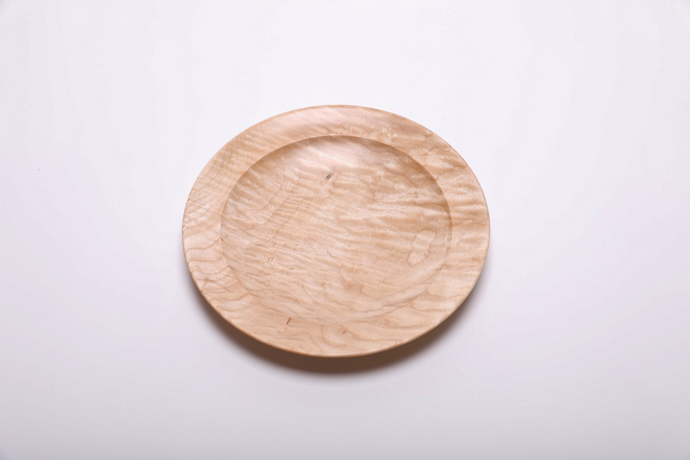Curly quilted maple shallow bowl top view rotated 135°, rare quilted maple grain and food-safe oil finish
