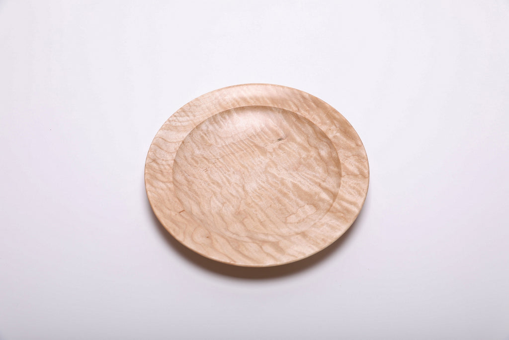 Curly quilted maple shallow bowl top view rotated 180°, full quilt figure visible across bowl surface
