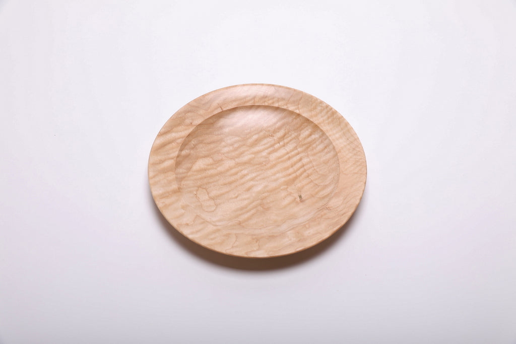 Curly quilted maple shallow bowl top view rotated 315°, dense chatoyant figure and natural oil finish