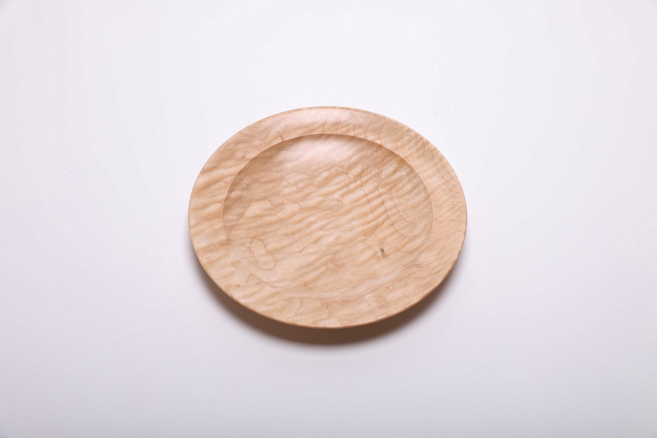 Curly quilted maple shallow bowl top view rotated 315°, dense chatoyant figure and natural oil finish