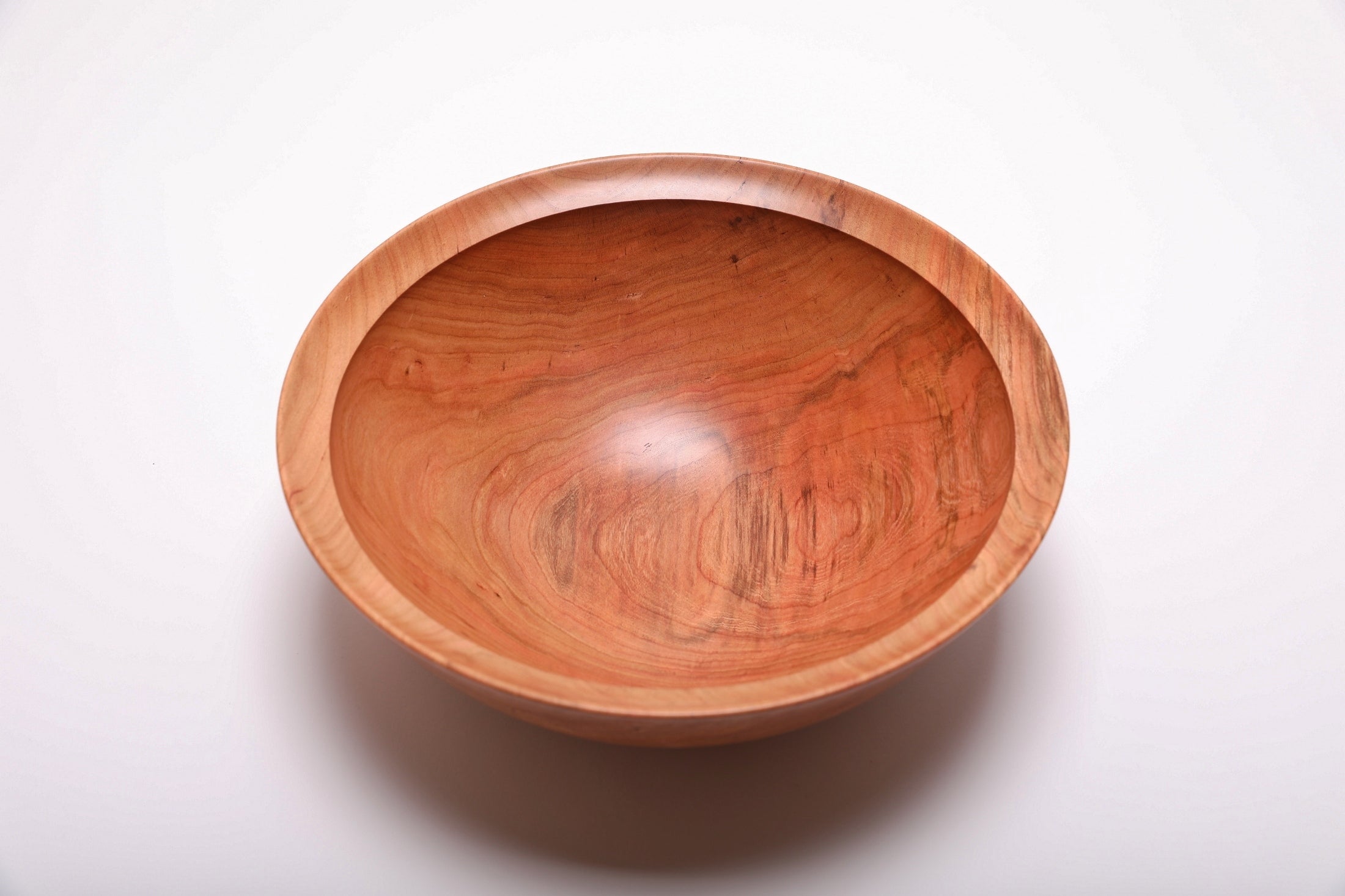 Spalted wild black cherry bowl top view rotated 90°, brown and cream spalting highlights on one side