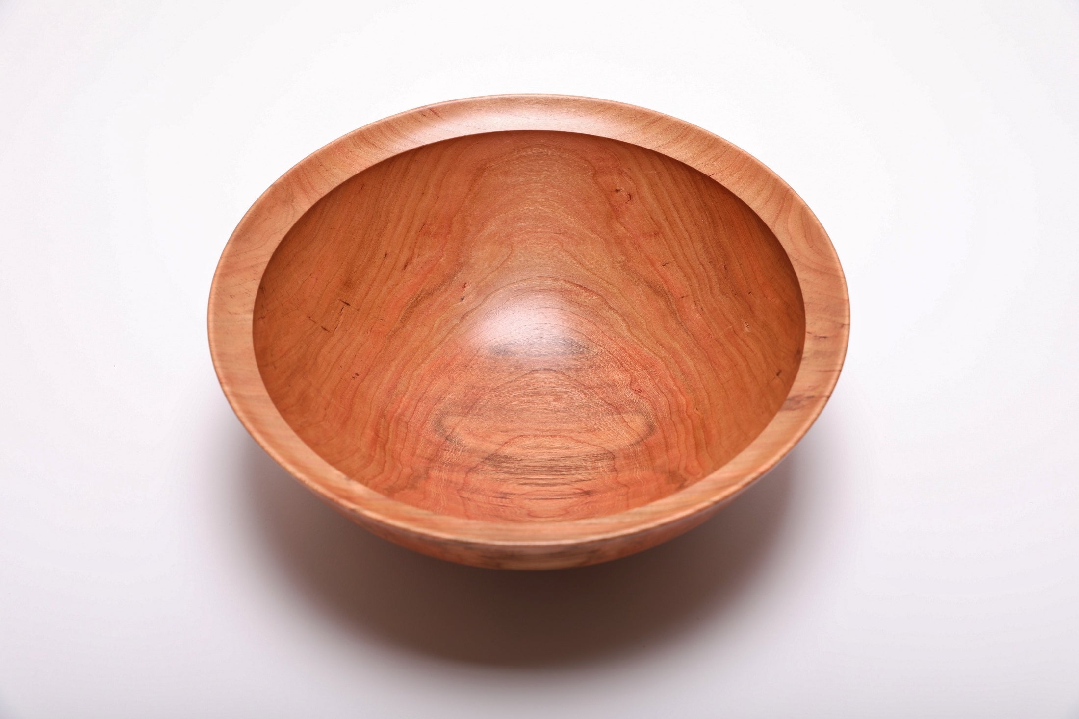 Spalted wild black cherry bowl top view rotated 180°, dark pink and copper coloration with amber growth rings