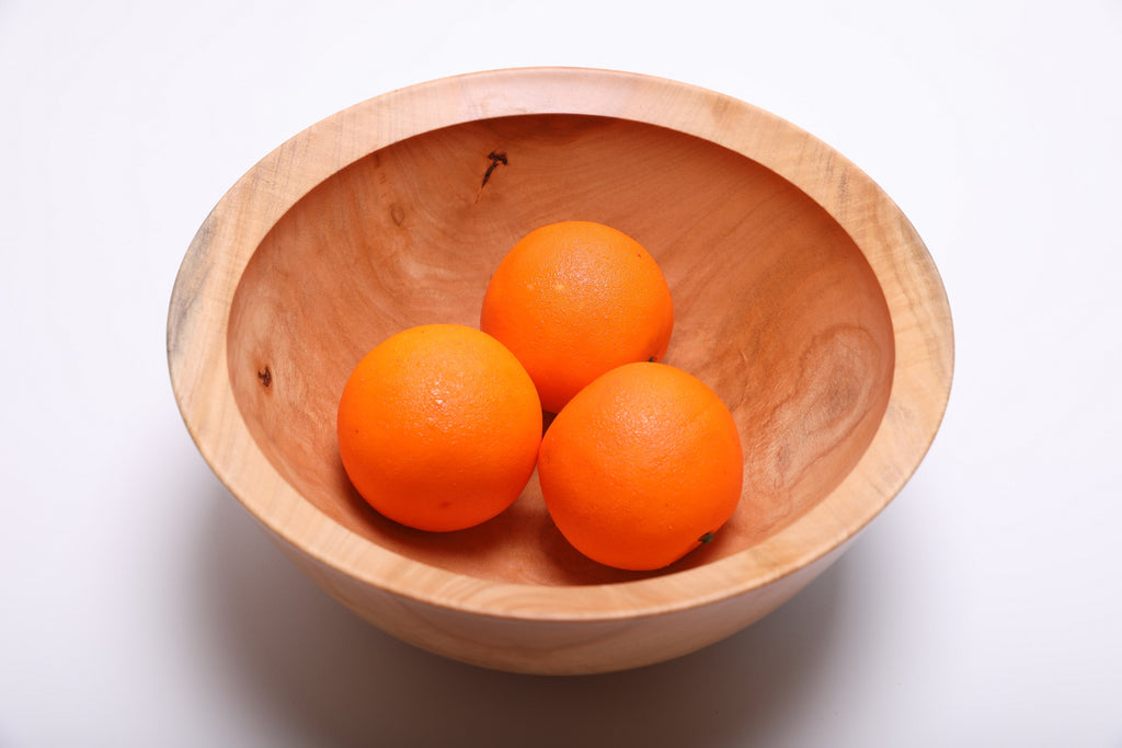 Spalted sugar maple fruit bowl filled with three oranges, showing scale and depth at 11 inches wide by 4 7/8 inches tall
