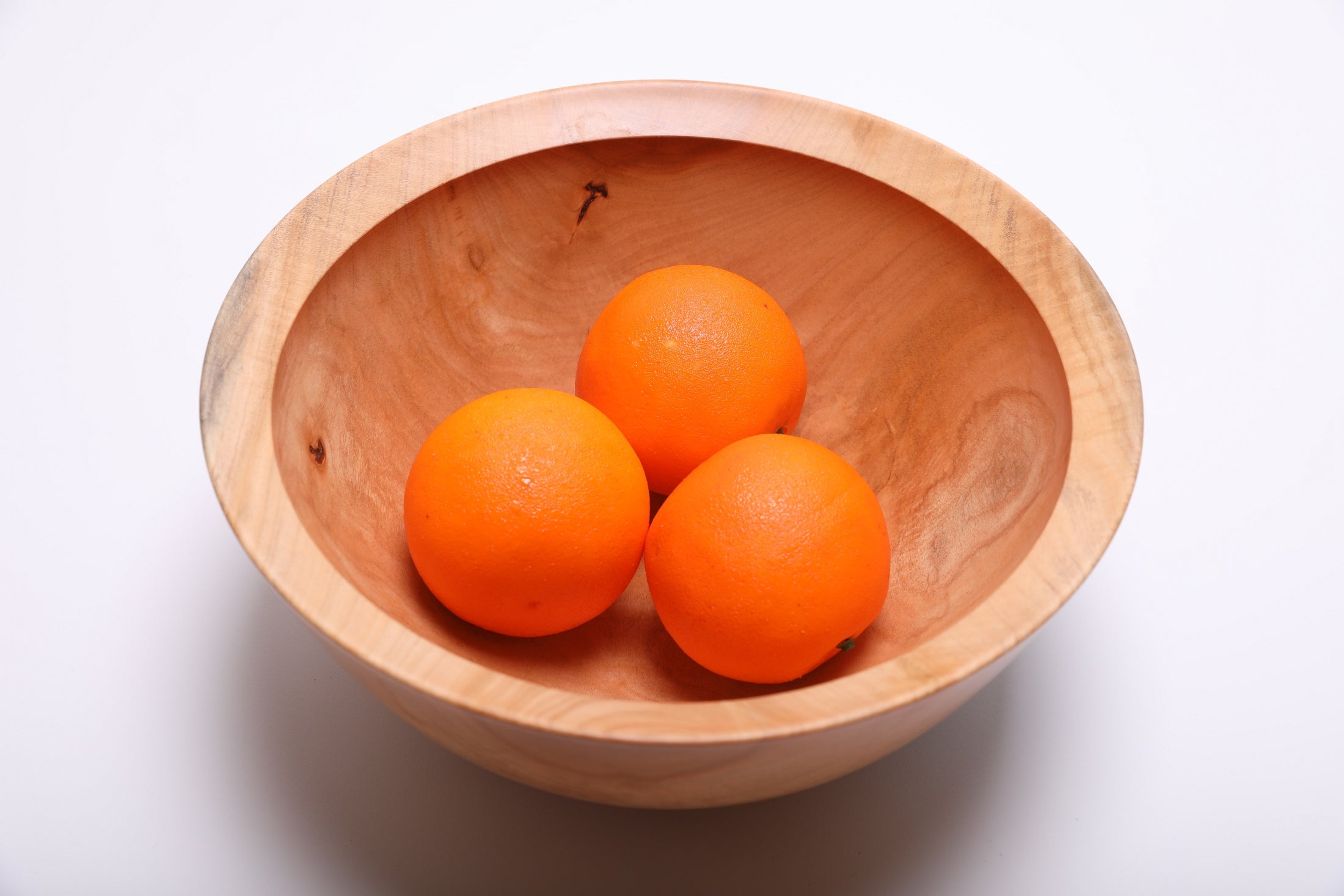 Spalted sugar maple fruit bowl filled with three oranges, showing scale and depth at 11 inches wide by 4 7/8 inches tall
