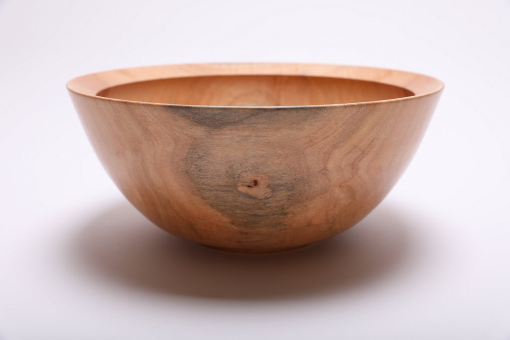 Side angle of spalted sugar maple bowl showing raised foot detail and natural oil finish on exterior grain